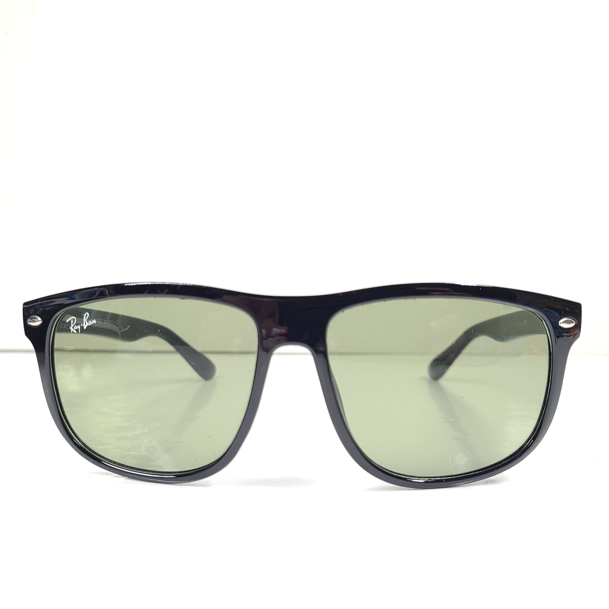 A pair of pre-owned black frame Ray-Ban sunglasses with green lenses for men