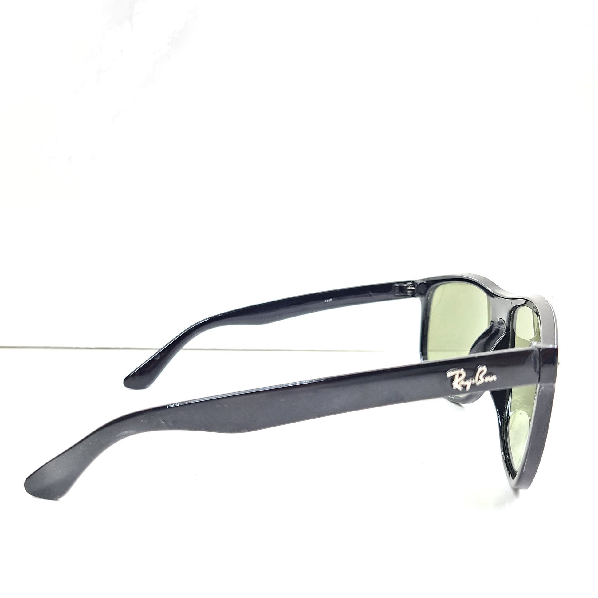 A pair of pre-owned black frame Ray-Ban sunglasses with green lenses for men