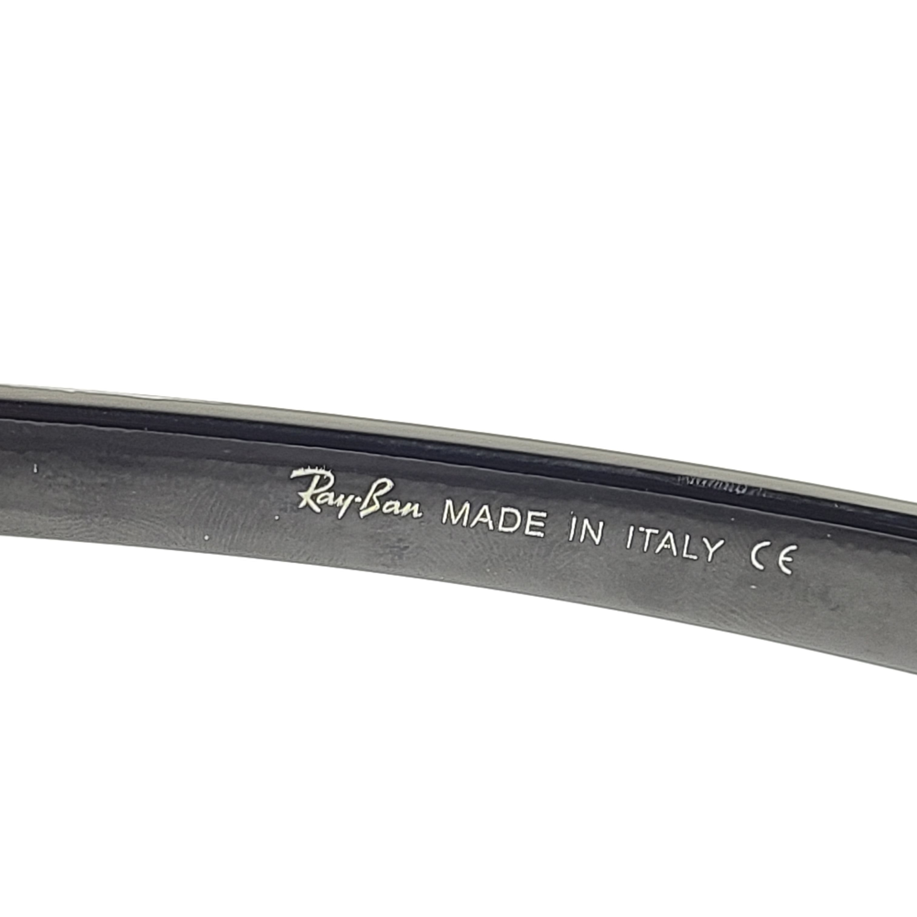 A pair of pre-owned black frame Ray-Ban sunglasses with green lenses for men
