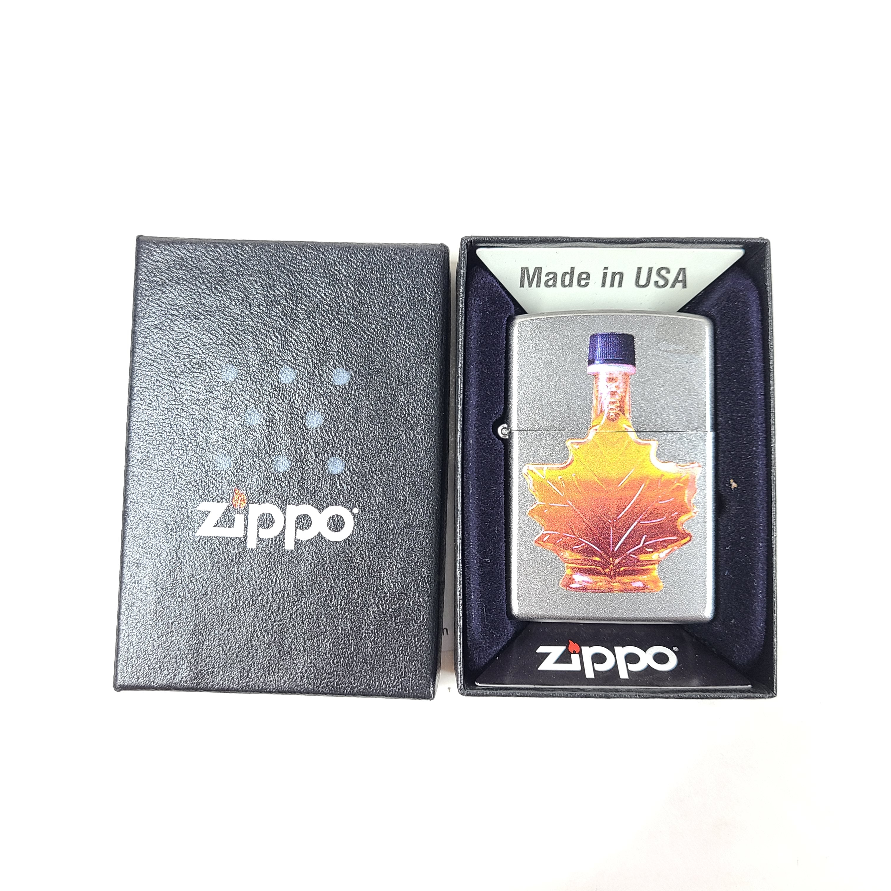 A Zippo lighter featuring a maple syrup design.