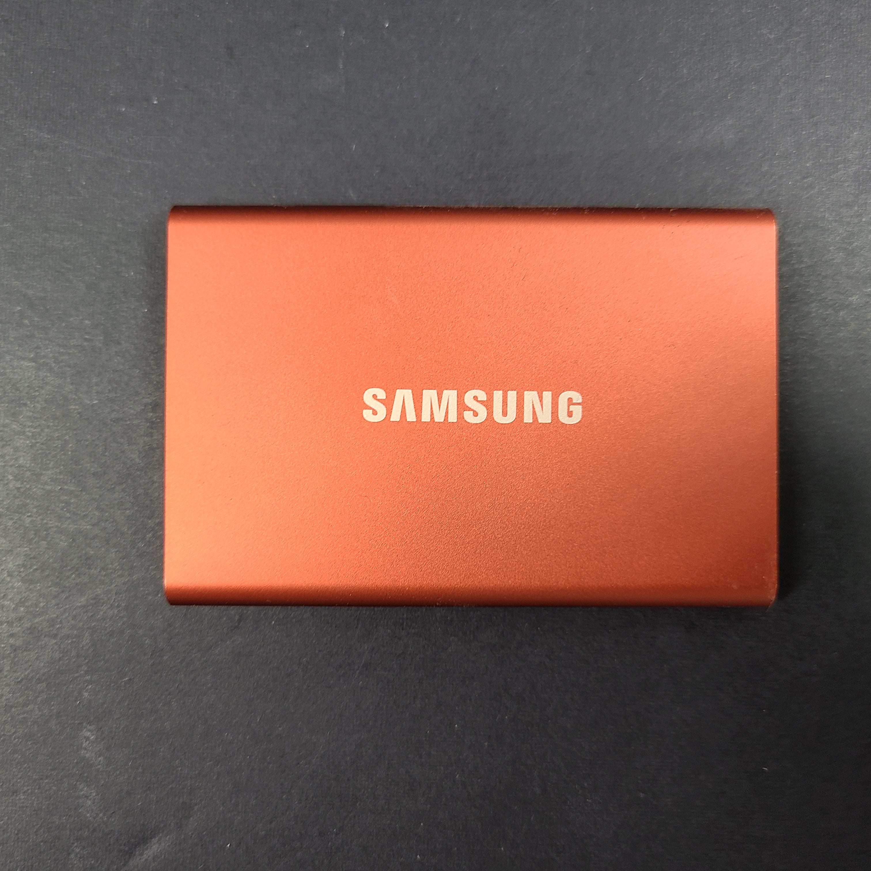 A sleek Samsung Portable SSD T7 in bold red color.