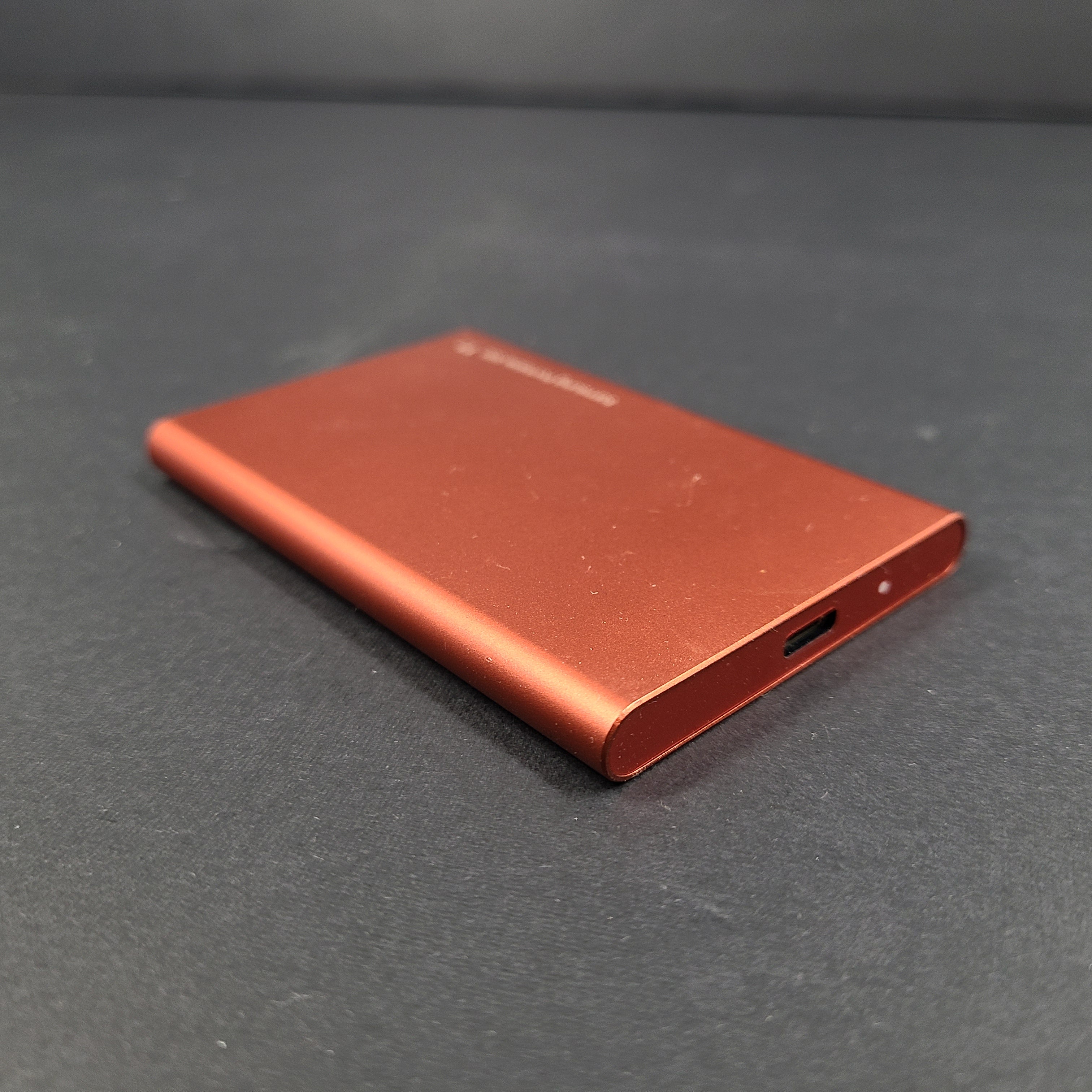 A sleek Samsung Portable SSD T7 in bold red color.
