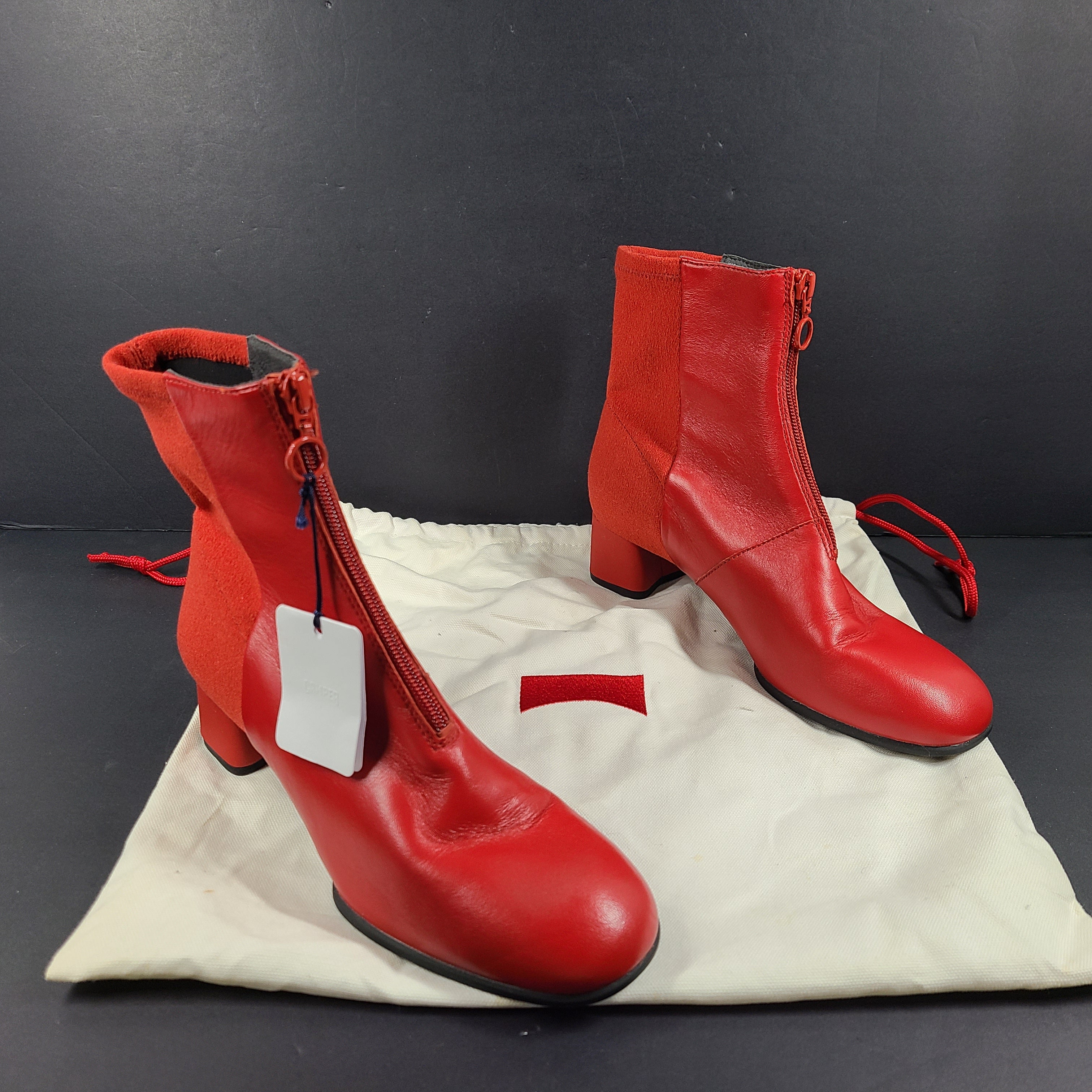 A pair of red leather ankle boots by Camper.