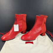 A pair of red leather ankle boots by Camper.