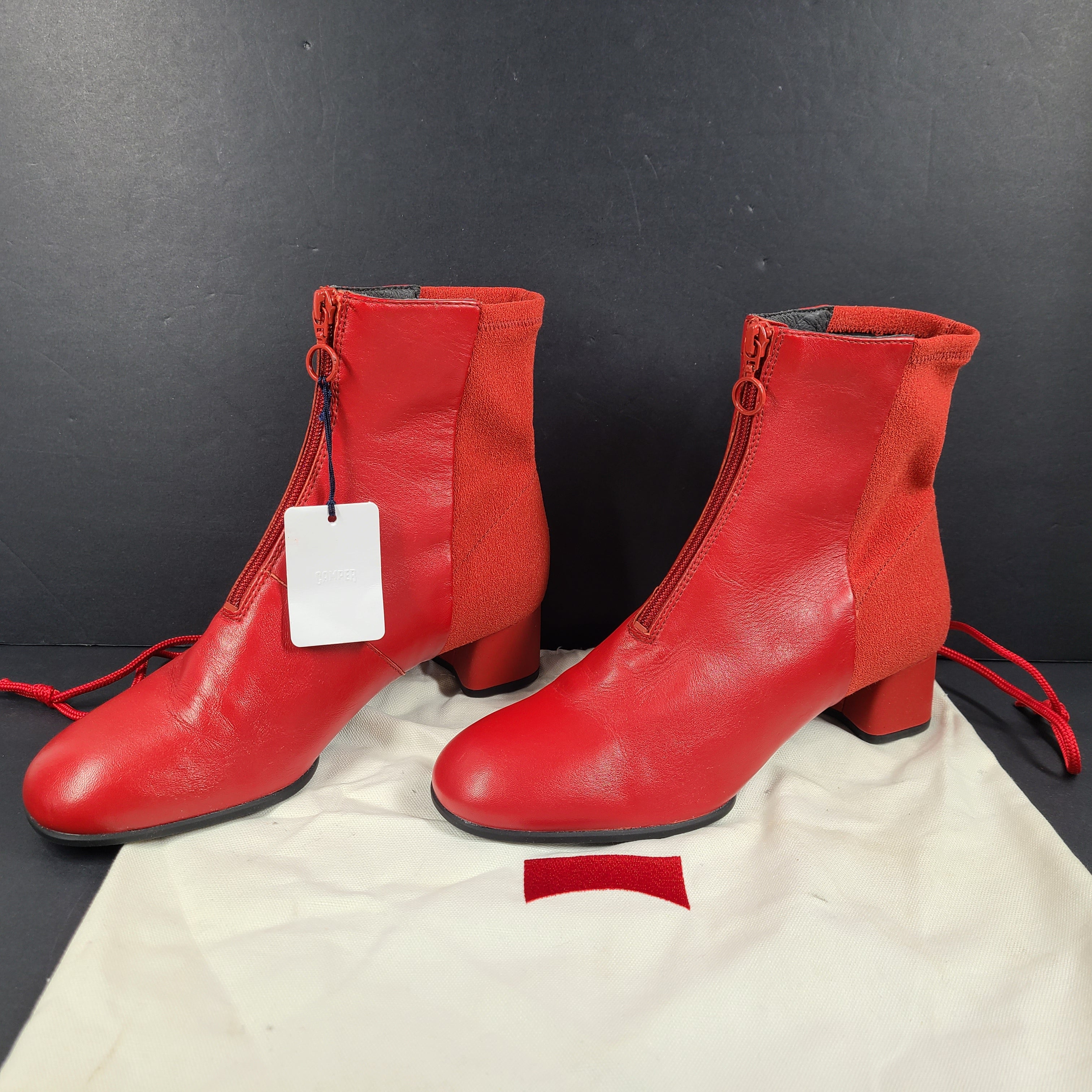 A pair of red leather ankle boots by Camper.