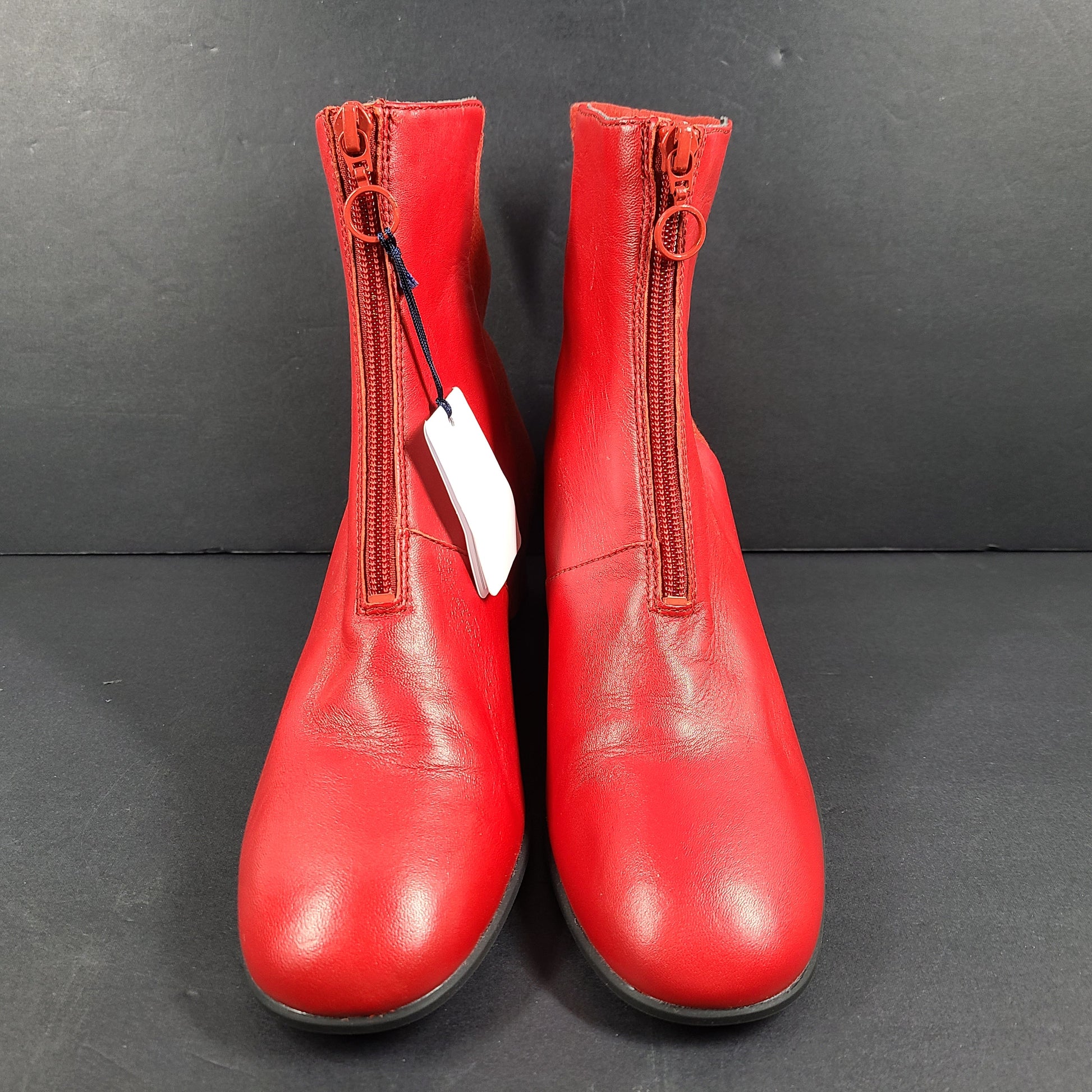 A pair of red leather ankle boots by Camper.