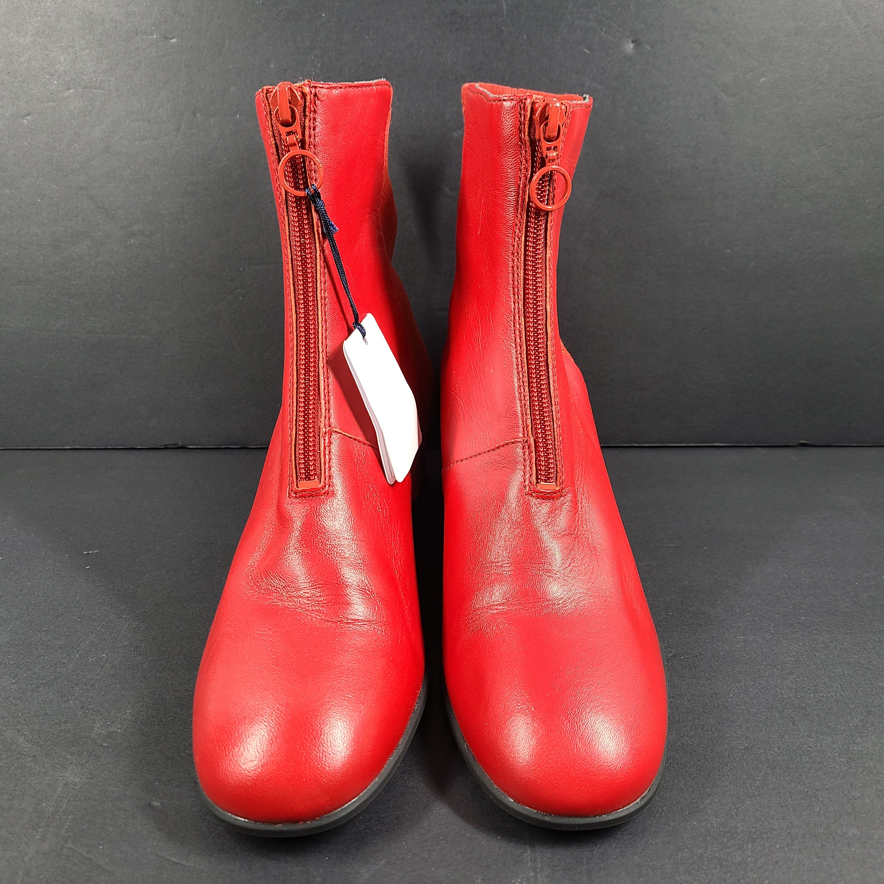 A pair of red leather ankle boots by Camper.