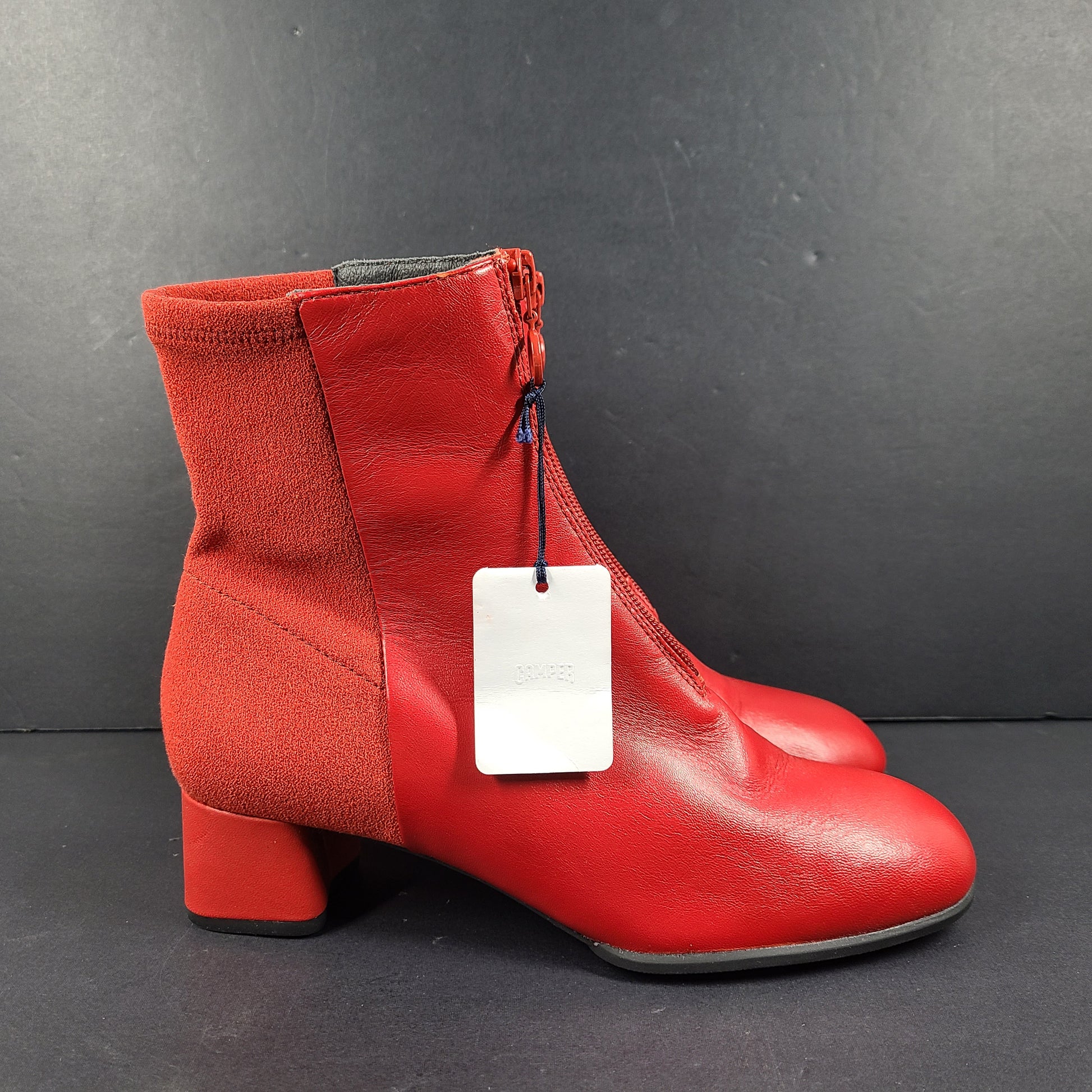 A pair of red leather ankle boots by Camper.