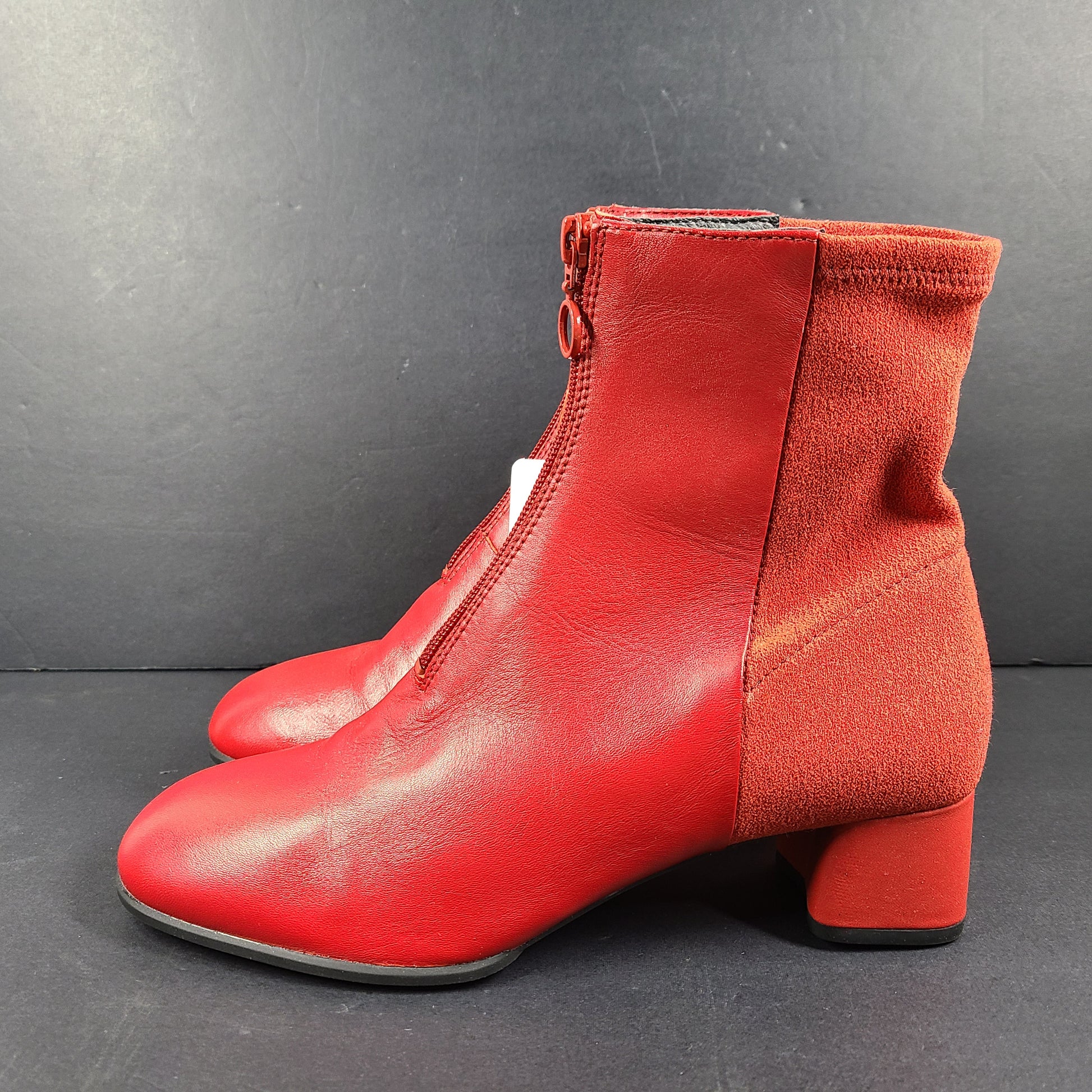 A pair of red leather ankle boots by Camper.