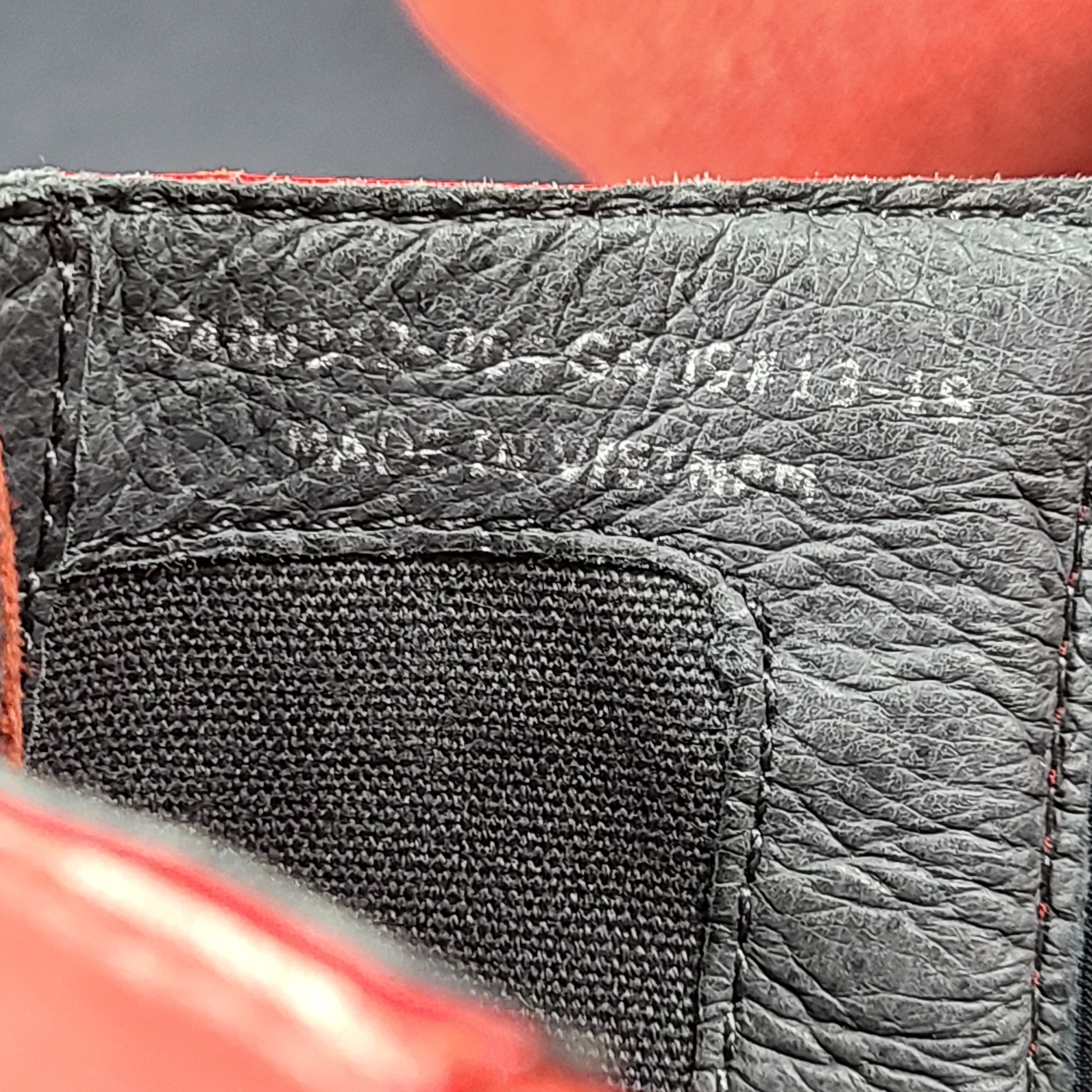 A pair of red leather ankle boots by Camper.
