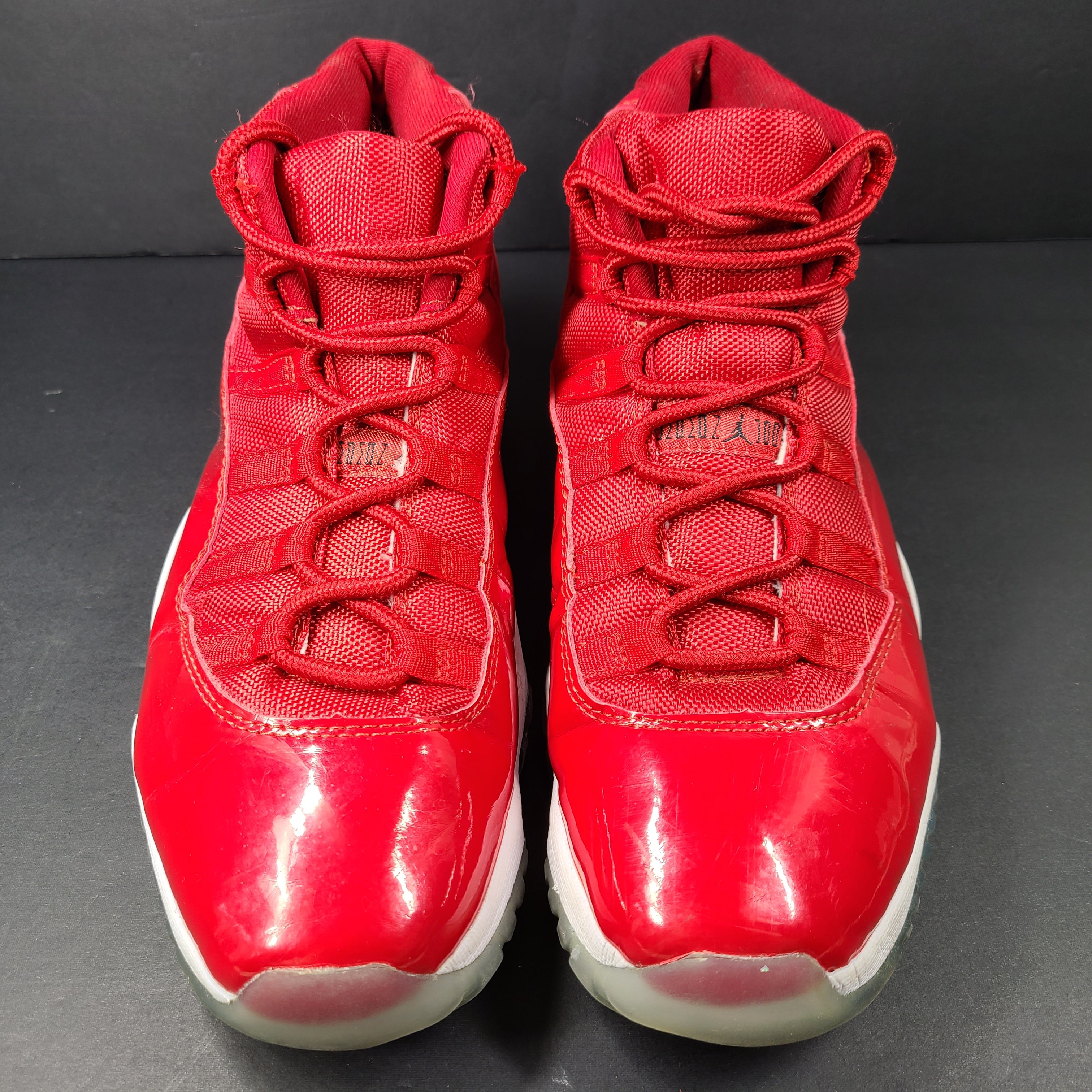 A pair of red Nike Air Jordan 11 Retro High men's sneakers.
