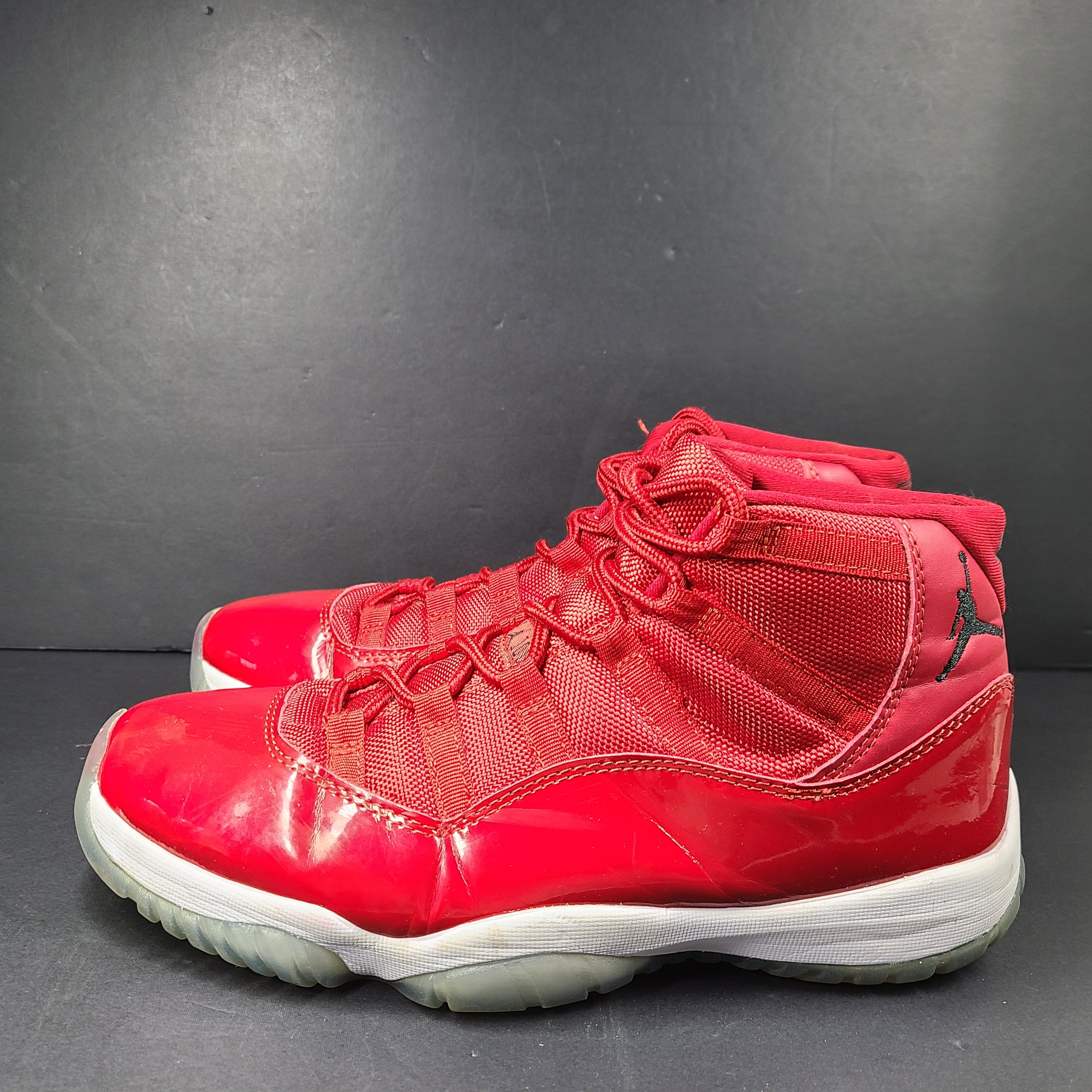 A pair of red Nike Air Jordan 11 Retro High men's sneakers.
