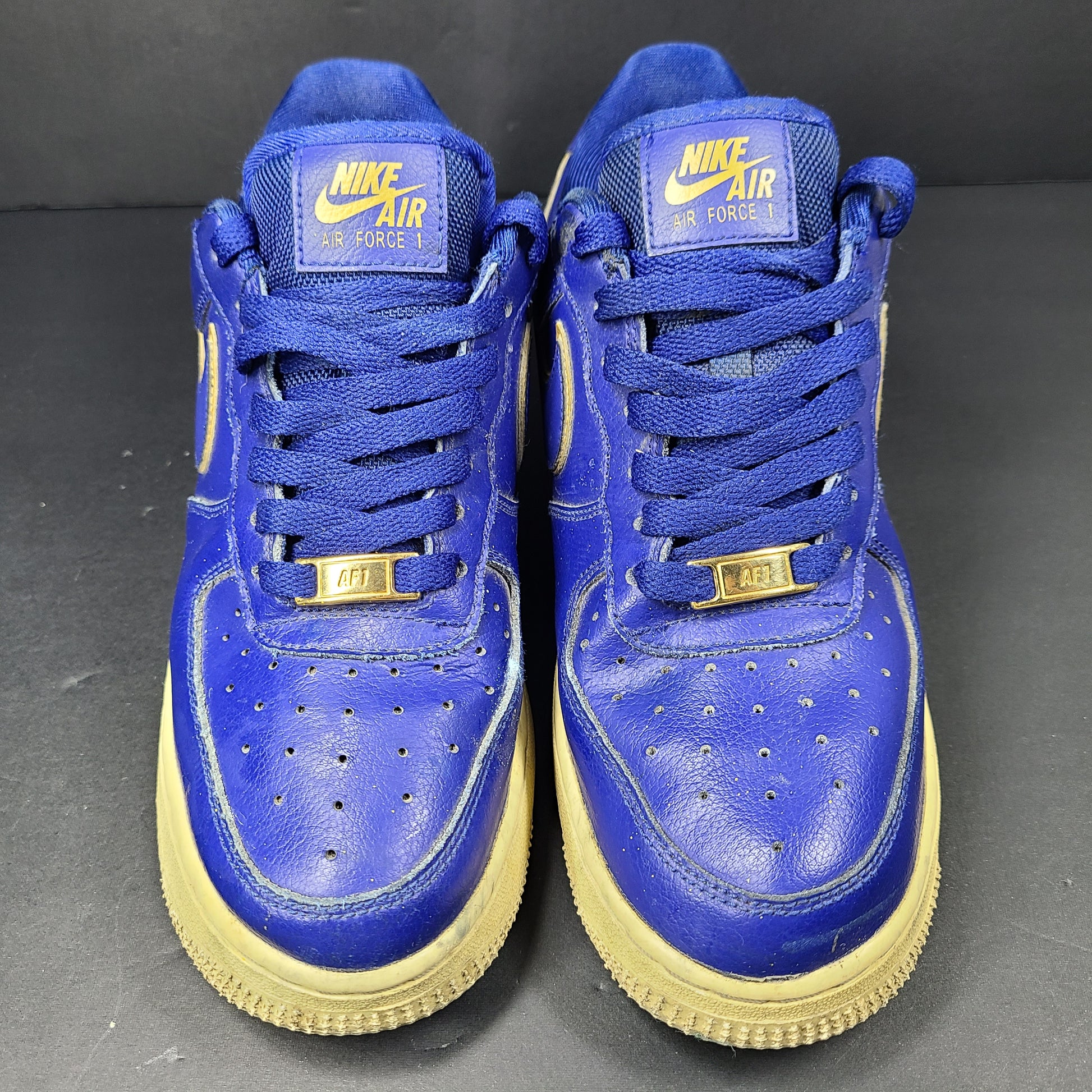 A pair of blue Nike Air Force 1 Low sneakers made of leather