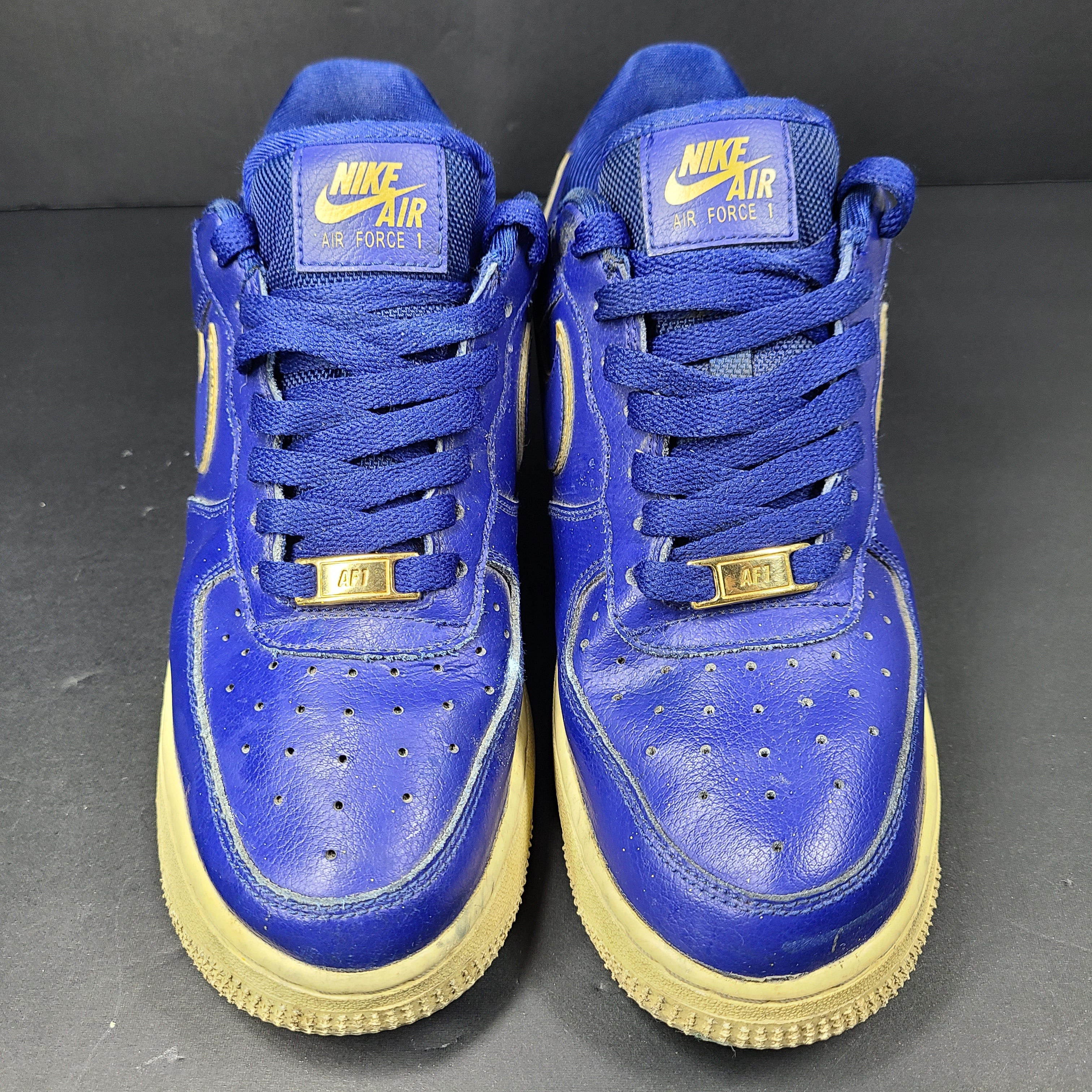A pair of blue Nike Air Force 1 Low sneakers made of leather