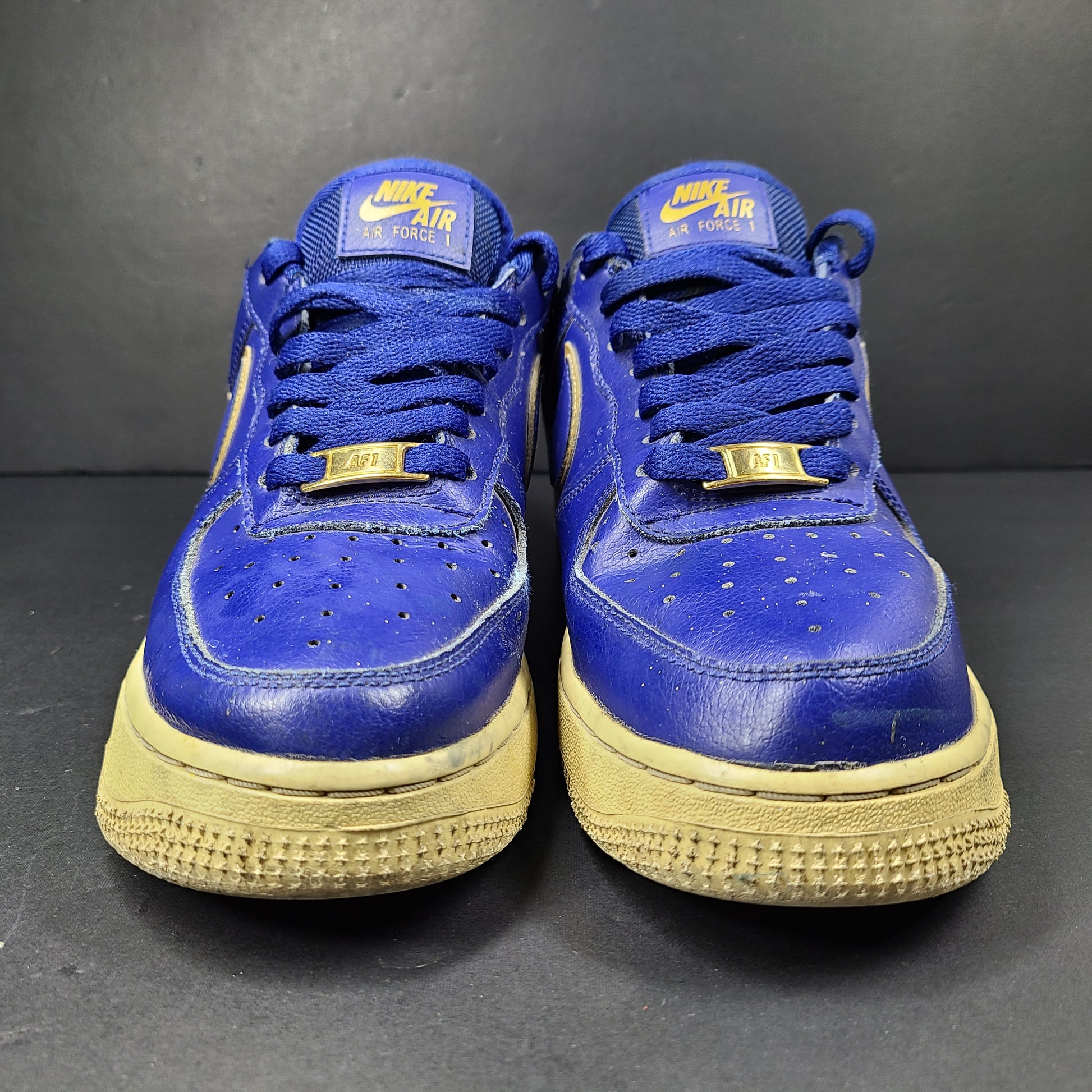 A pair of blue Nike Air Force 1 Low sneakers made of leather