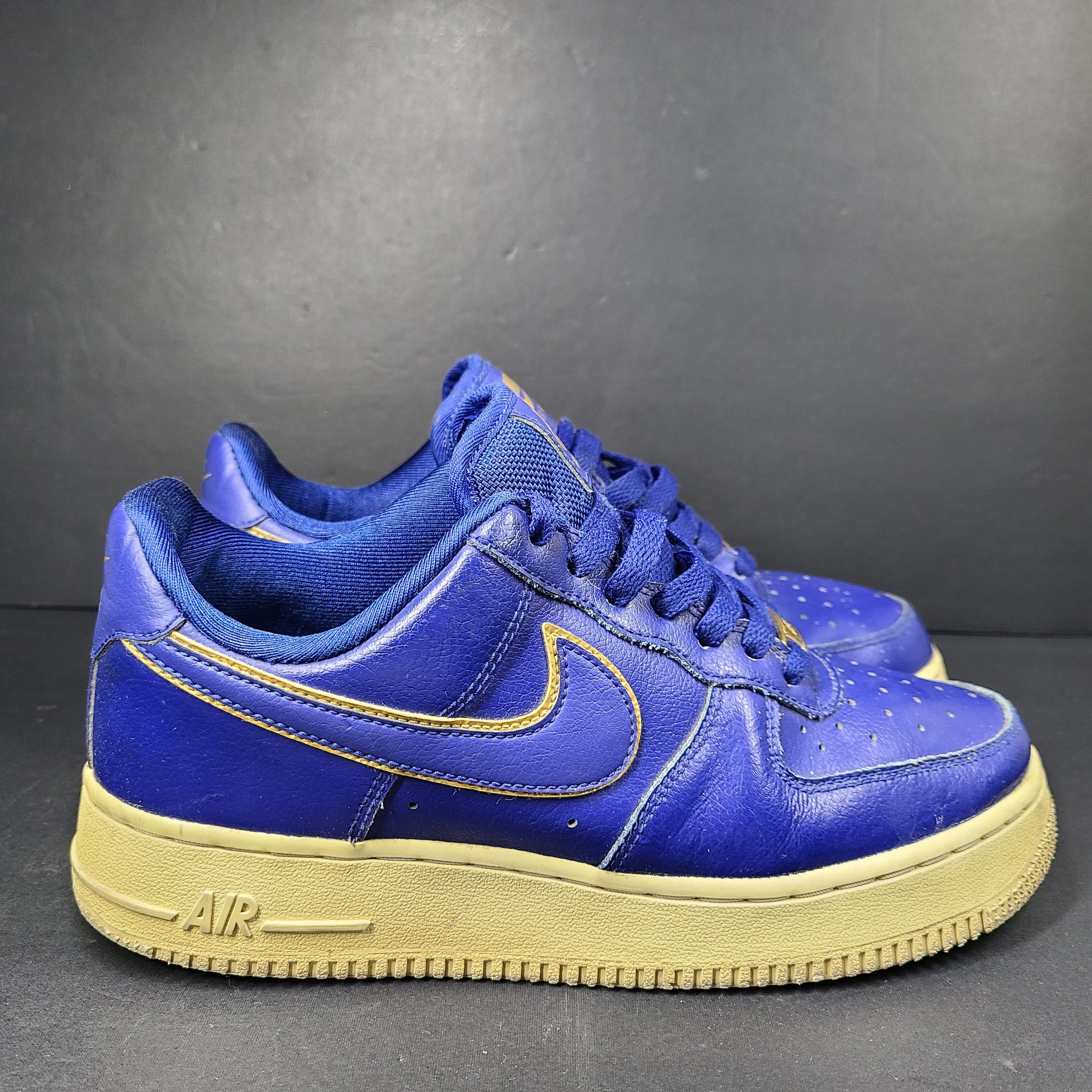 A pair of blue Nike Air Force 1 Low sneakers made of leather