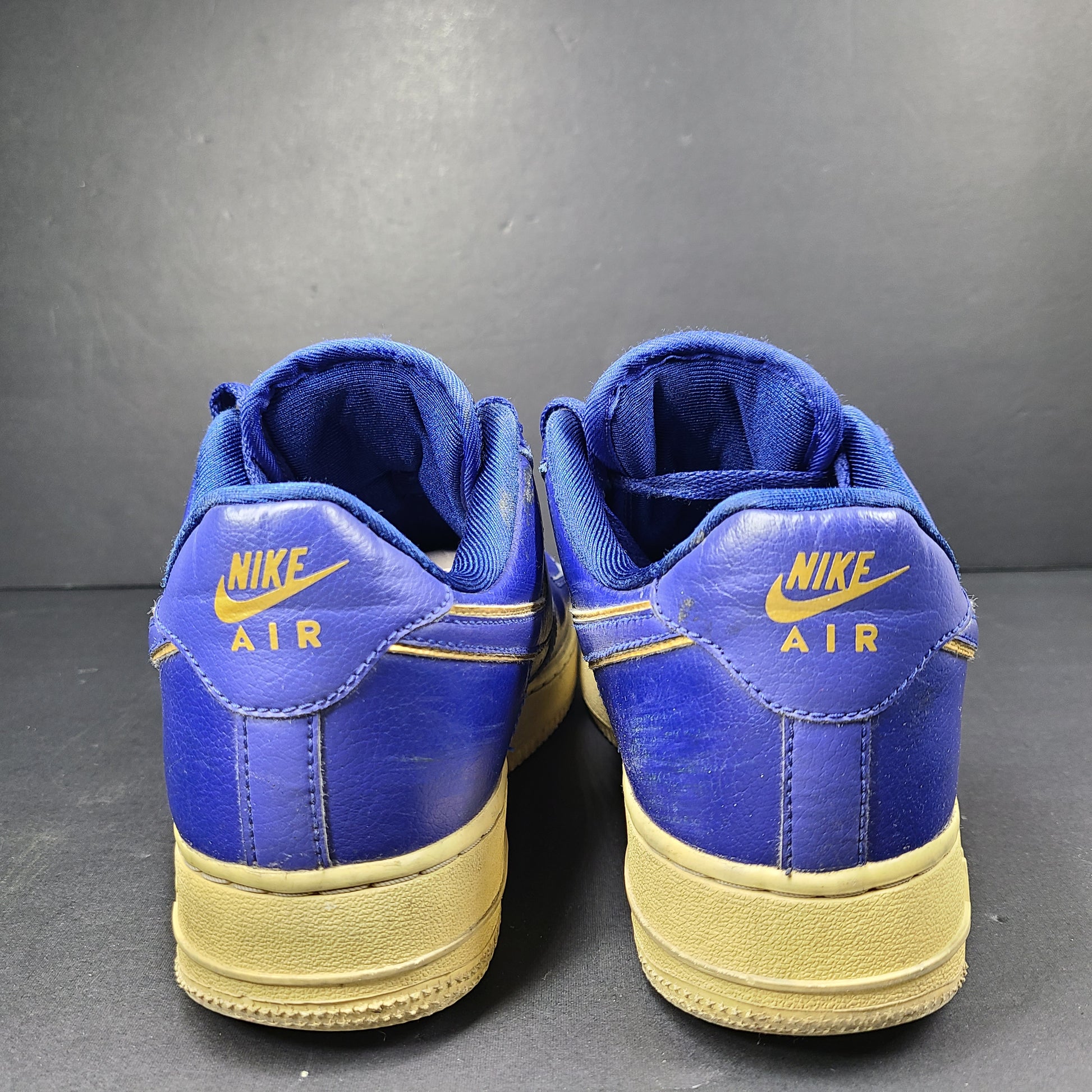 A pair of blue Nike Air Force 1 Low sneakers made of leather