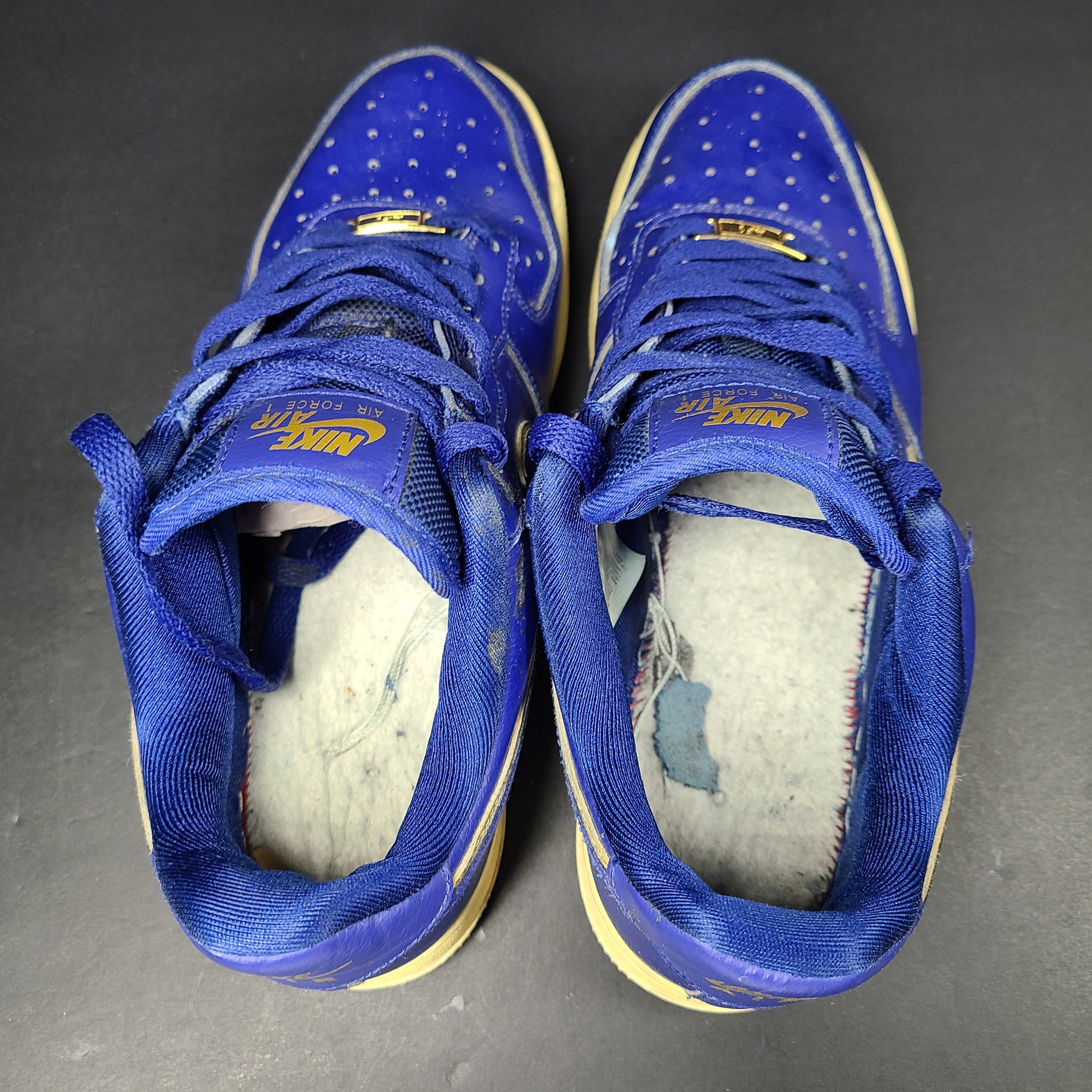 A pair of blue Nike Air Force 1 Low sneakers made of leather
