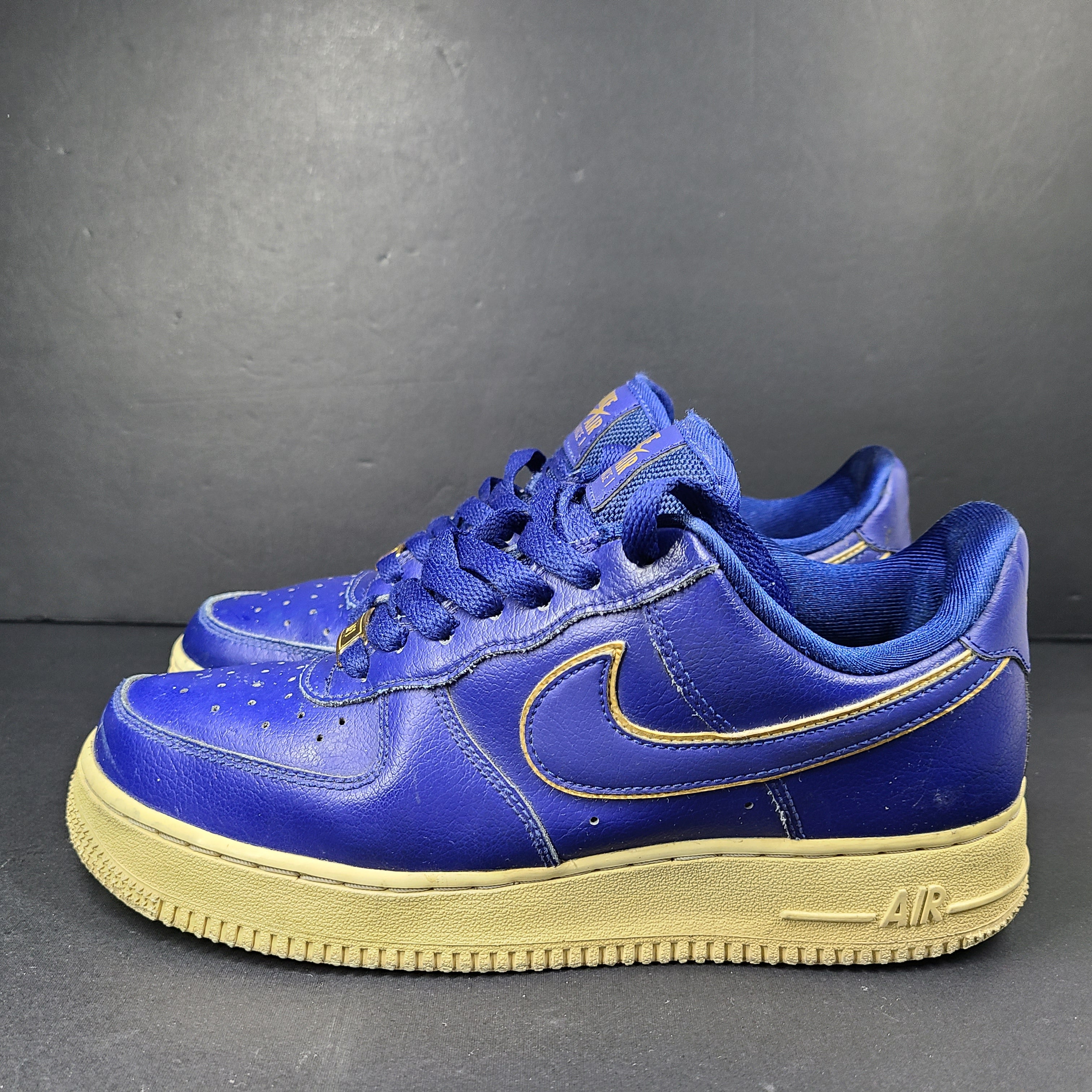 A pair of blue Nike Air Force 1 Low sneakers made of leather