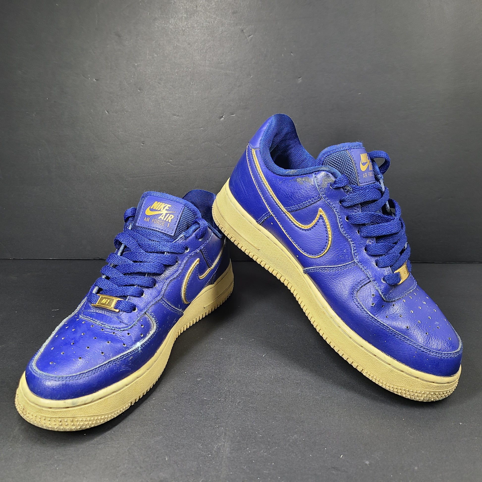 A pair of blue Nike Air Force 1 Low sneakers made of leather