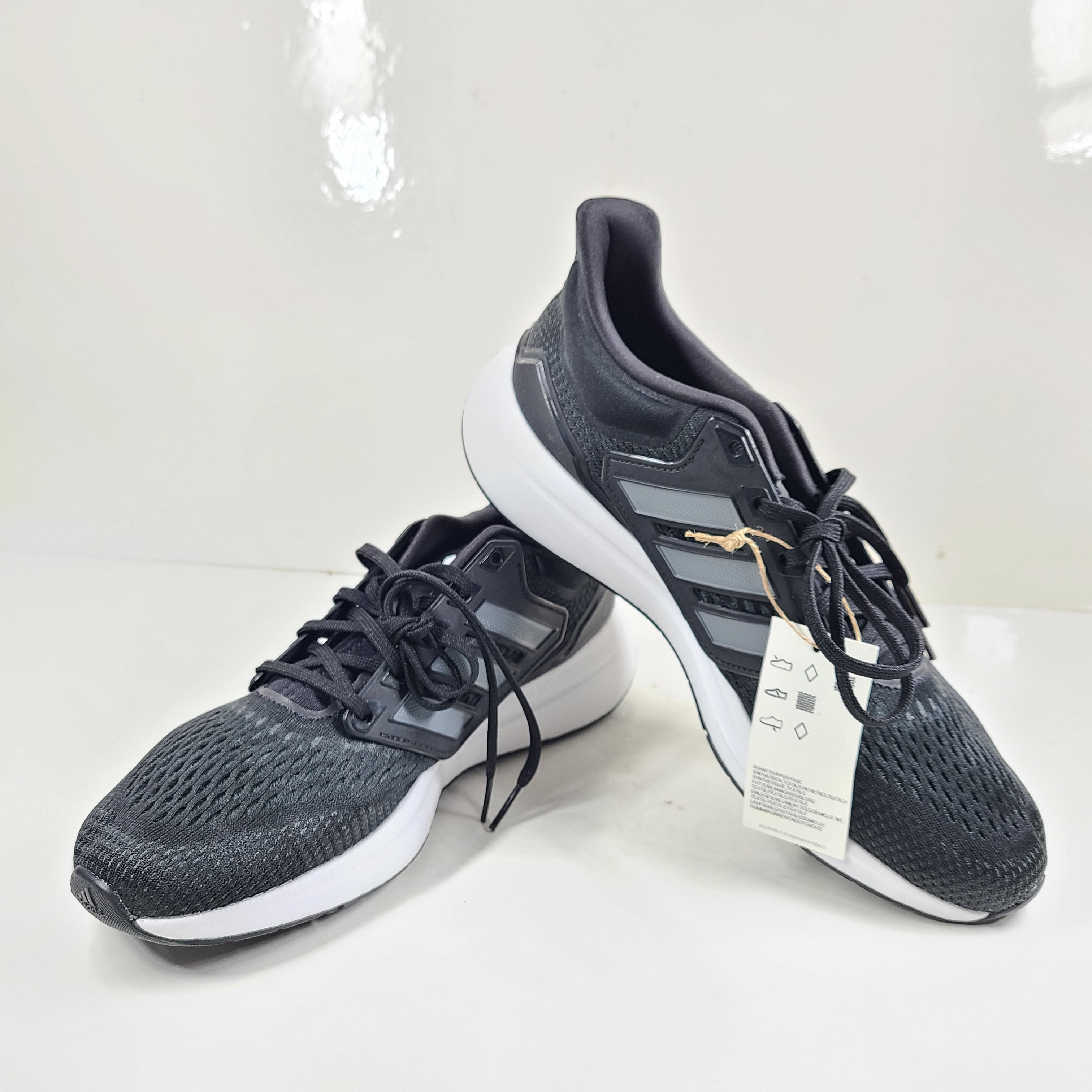 A pair of Adidas EQ21 men's black running shoes.