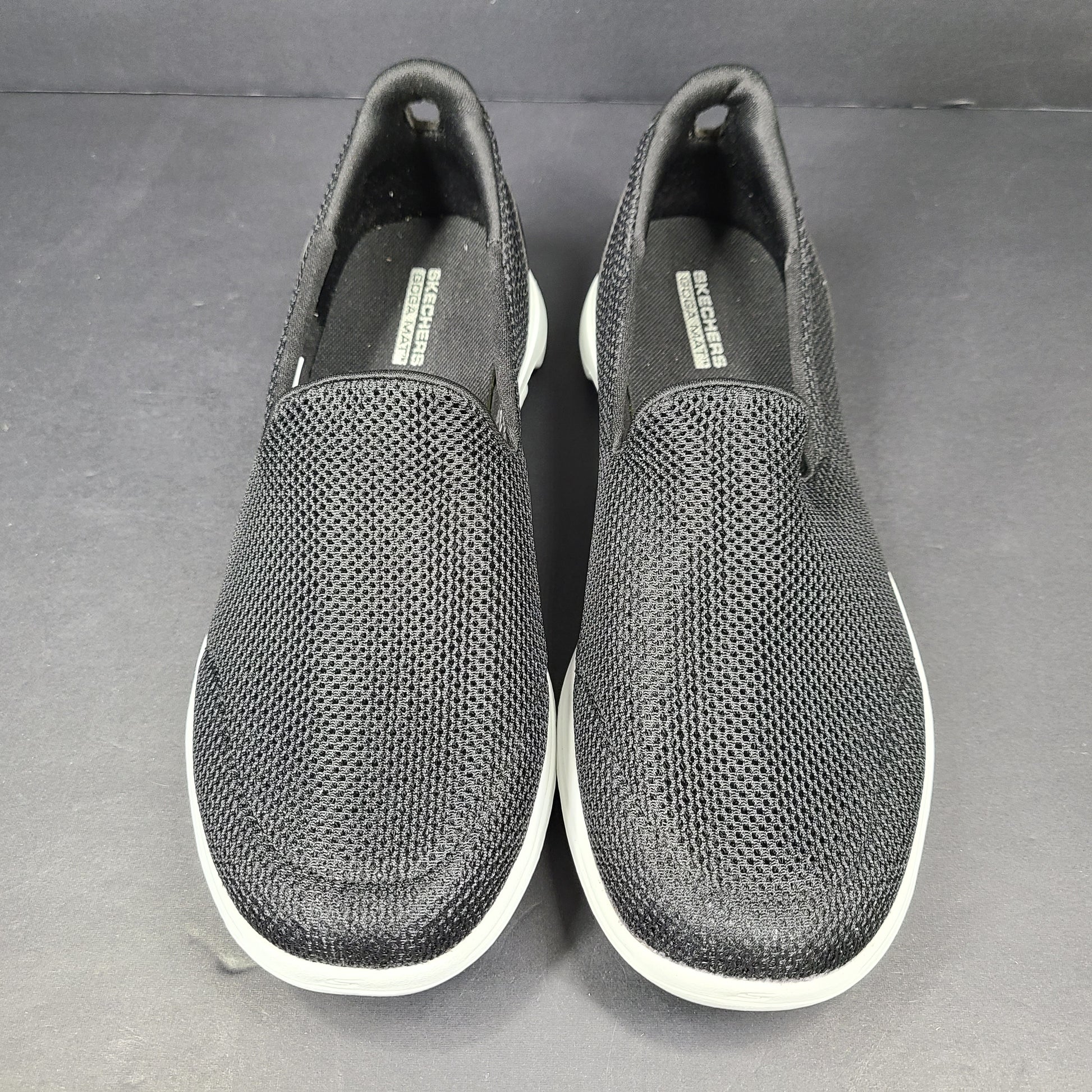 A pair of comfortable Skechers Go Walk 5 Slip-On Shoes in black, size 9.