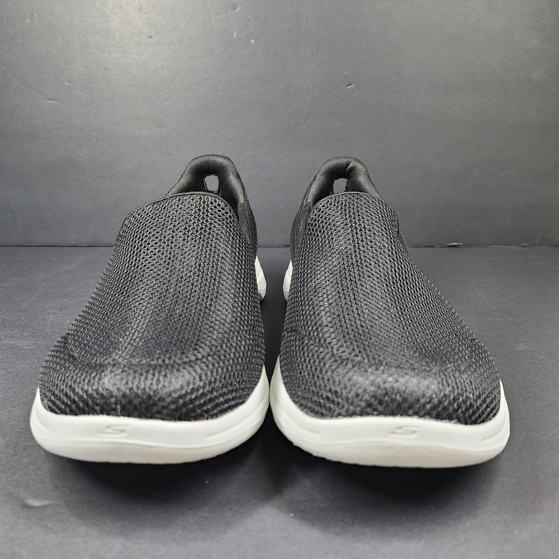 A pair of comfortable Skechers Go Walk 5 Slip-On Shoes in black, size 9.