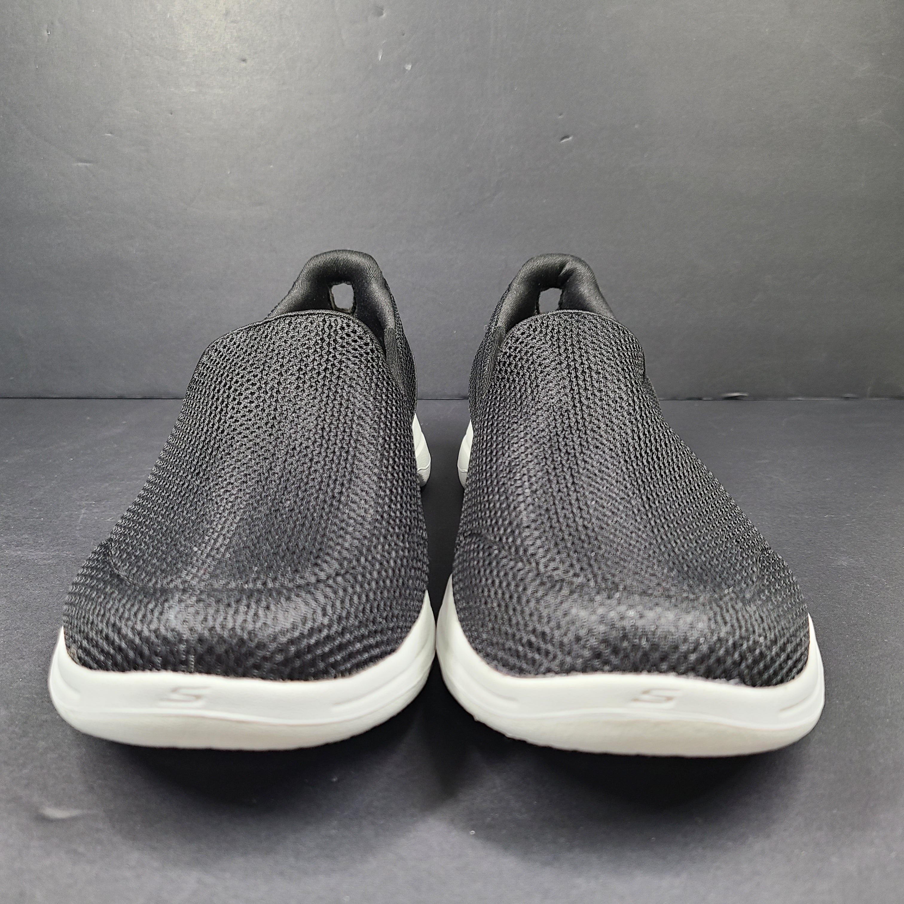 A pair of comfortable Skechers Go Walk 5 Slip-On Shoes in black, size 9.