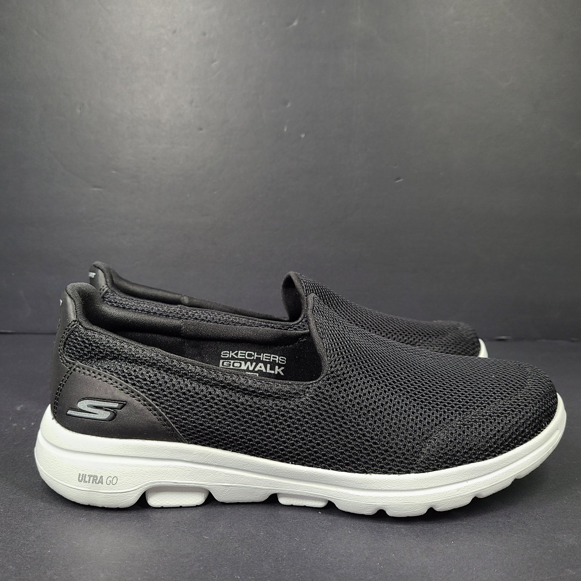 A pair of comfortable Skechers Go Walk 5 Slip-On Shoes in black, size 9.