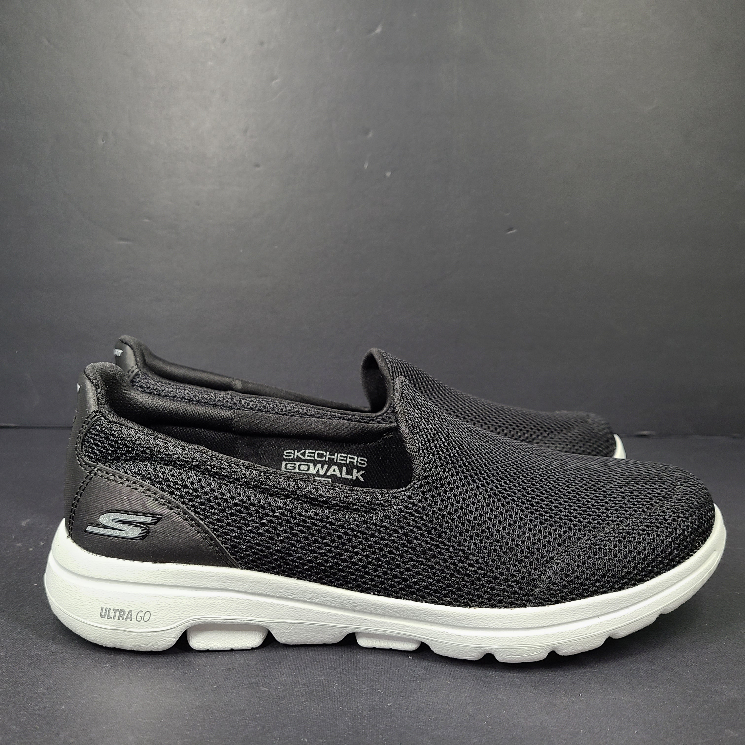 A pair of comfortable Skechers Go Walk 5 Slip-On Shoes in black, size 9.