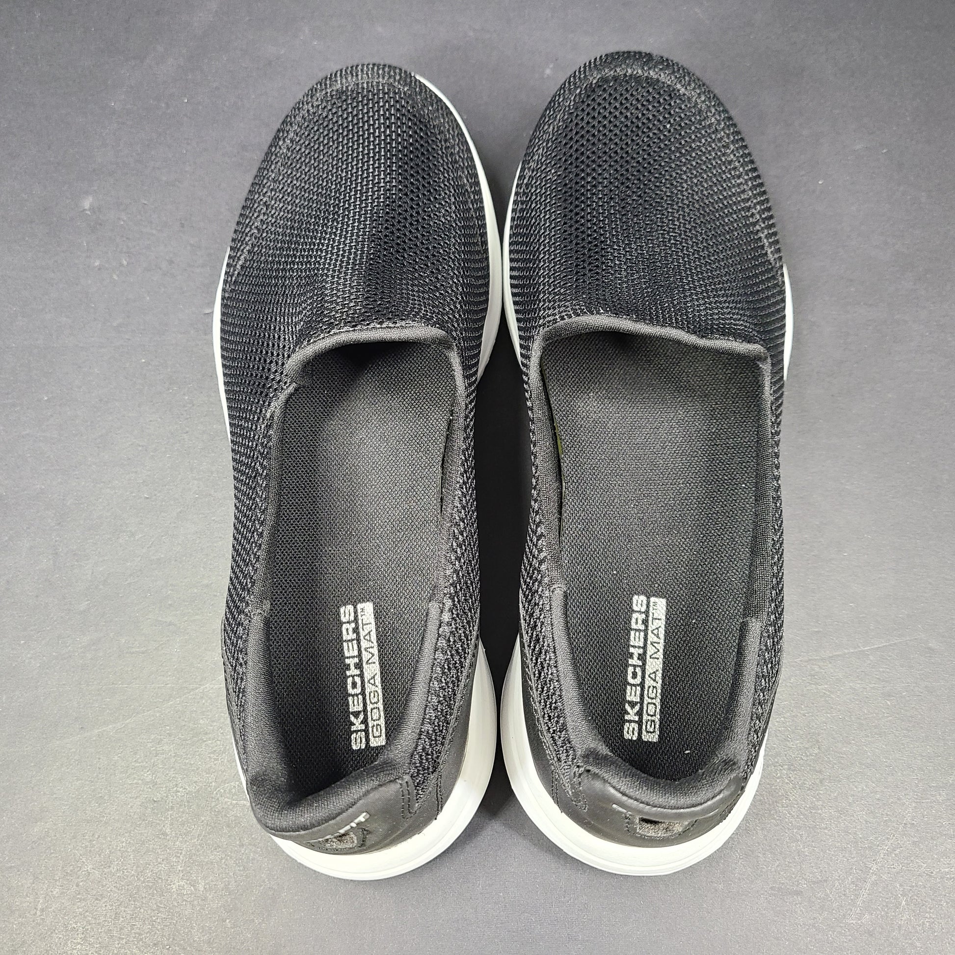 A pair of comfortable Skechers Go Walk 5 Slip-On Shoes in black, size 9.