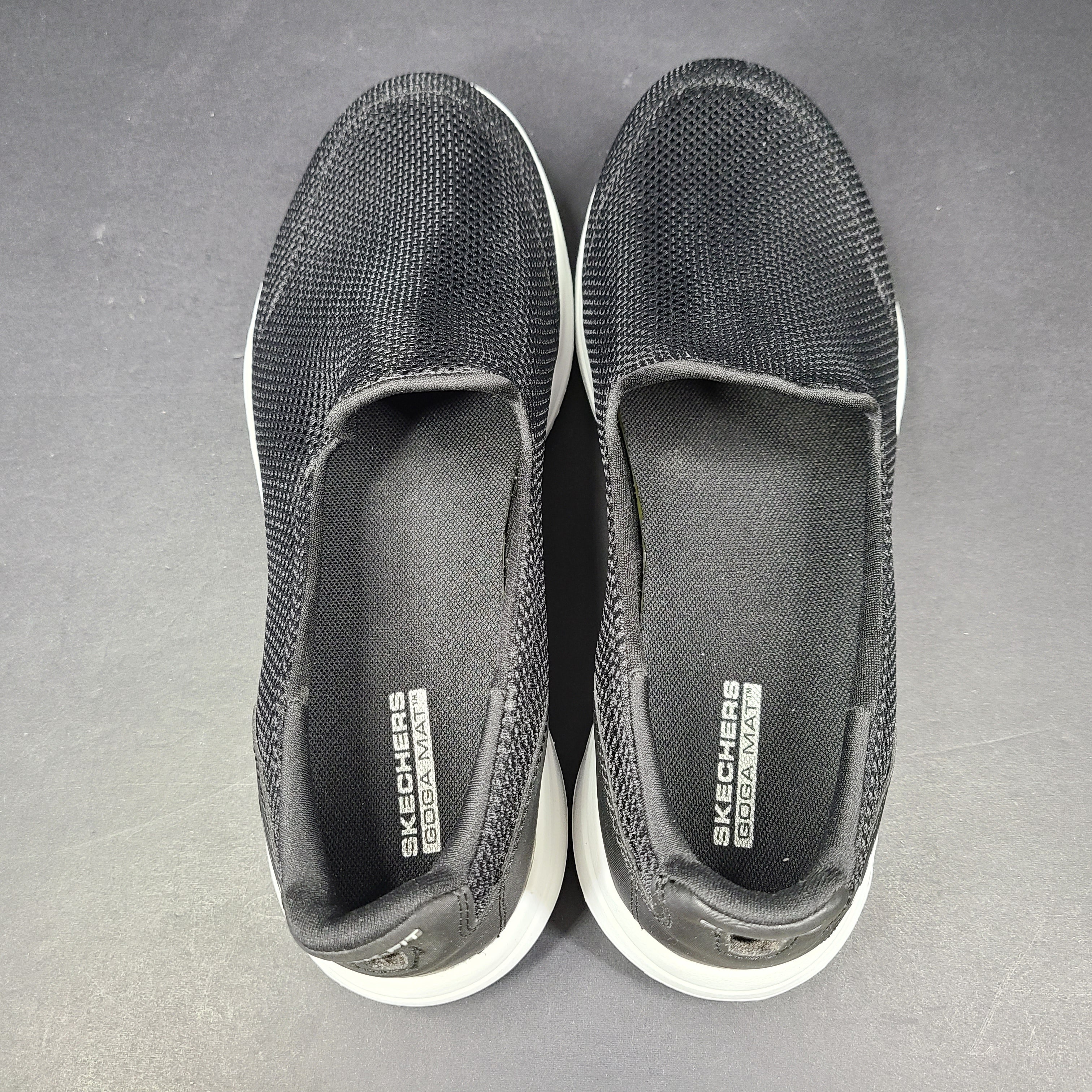 A pair of comfortable Skechers Go Walk 5 Slip-On Shoes in black, size 9.