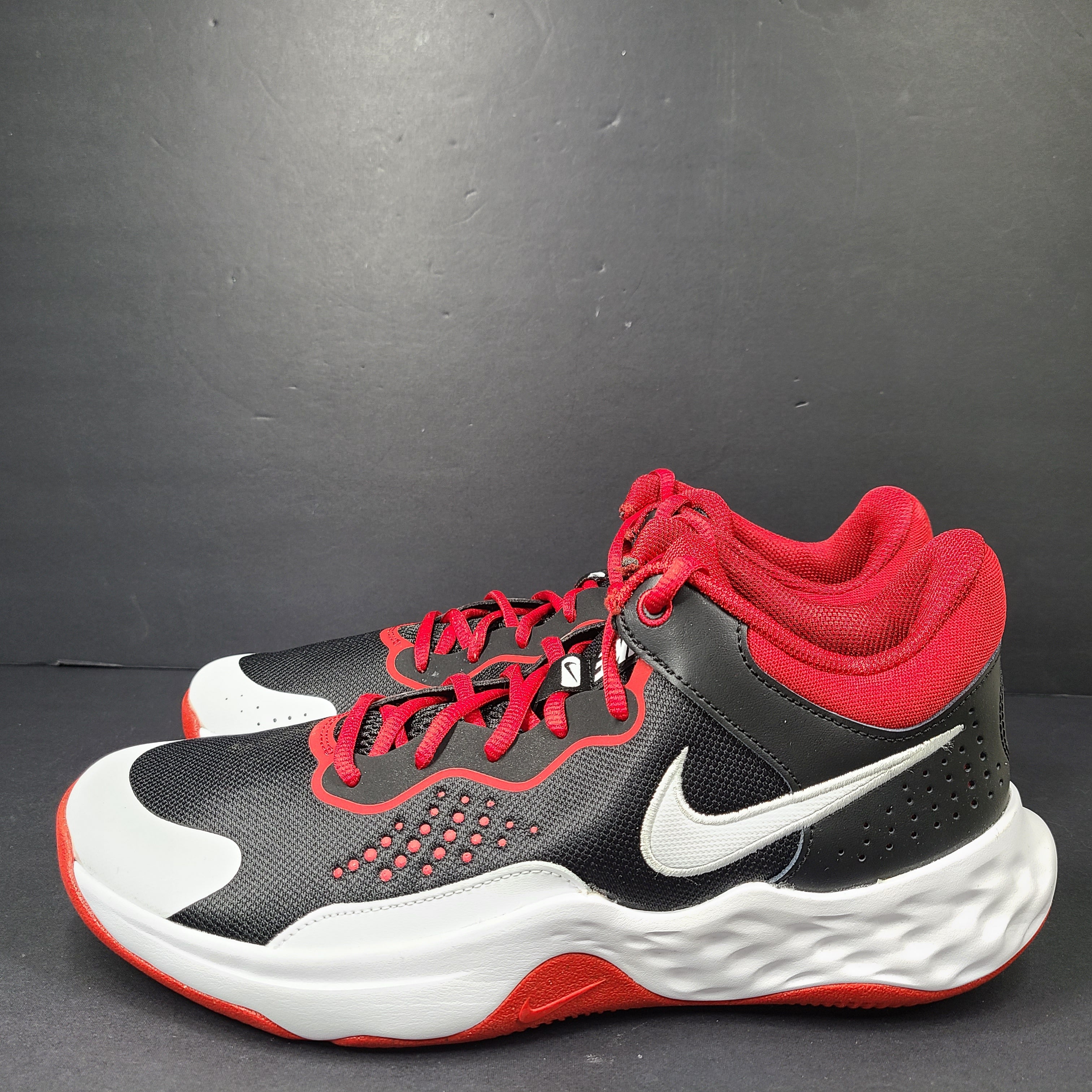 A pair of Nike men’s athletic shoes in black, red, and white.