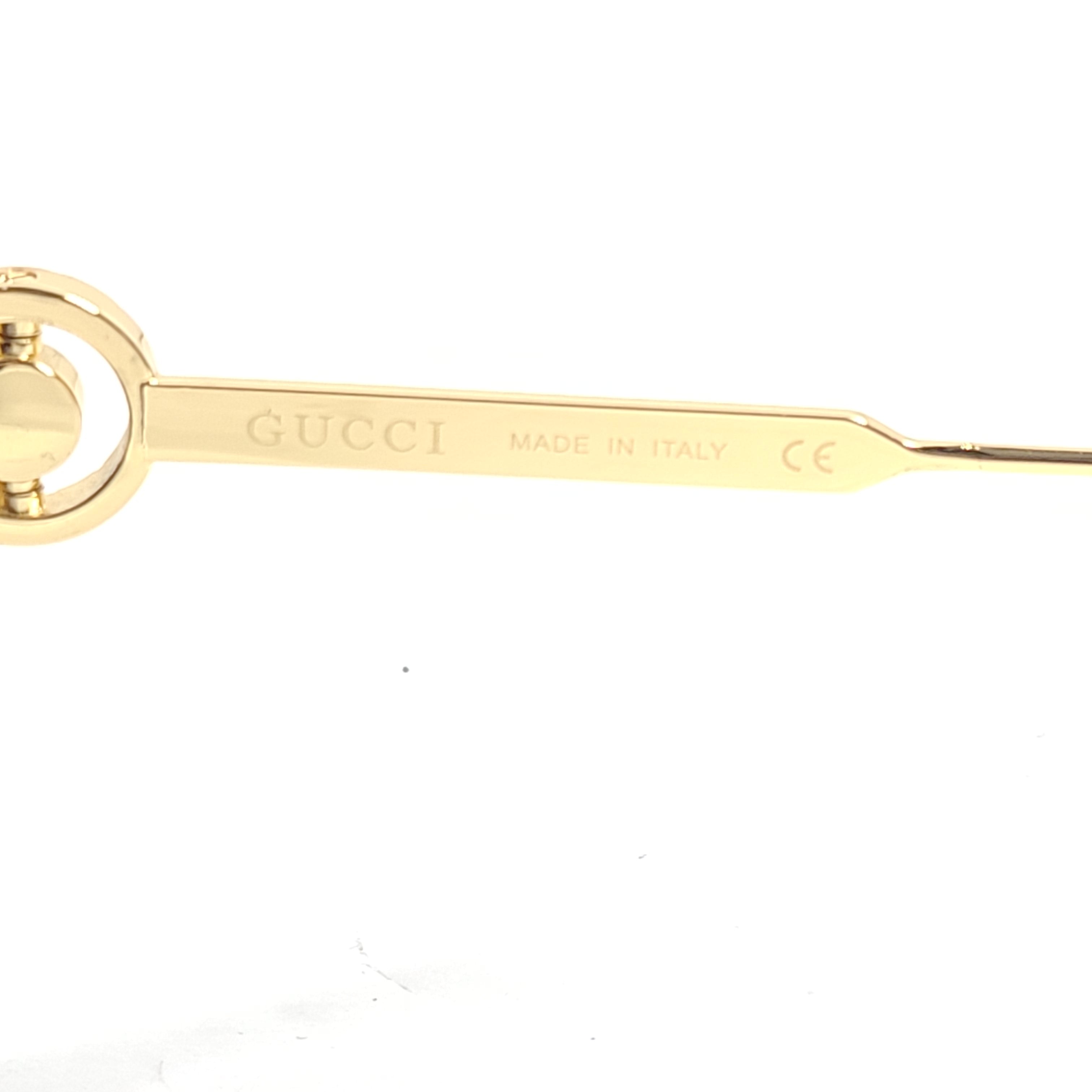 A stylish pair of Gucci women's sunglasses in black and gold gradient.
