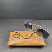 Fashionable Ray-Ban RB3548 Hexagonal Sunglasses with gold frames and blue lenses.