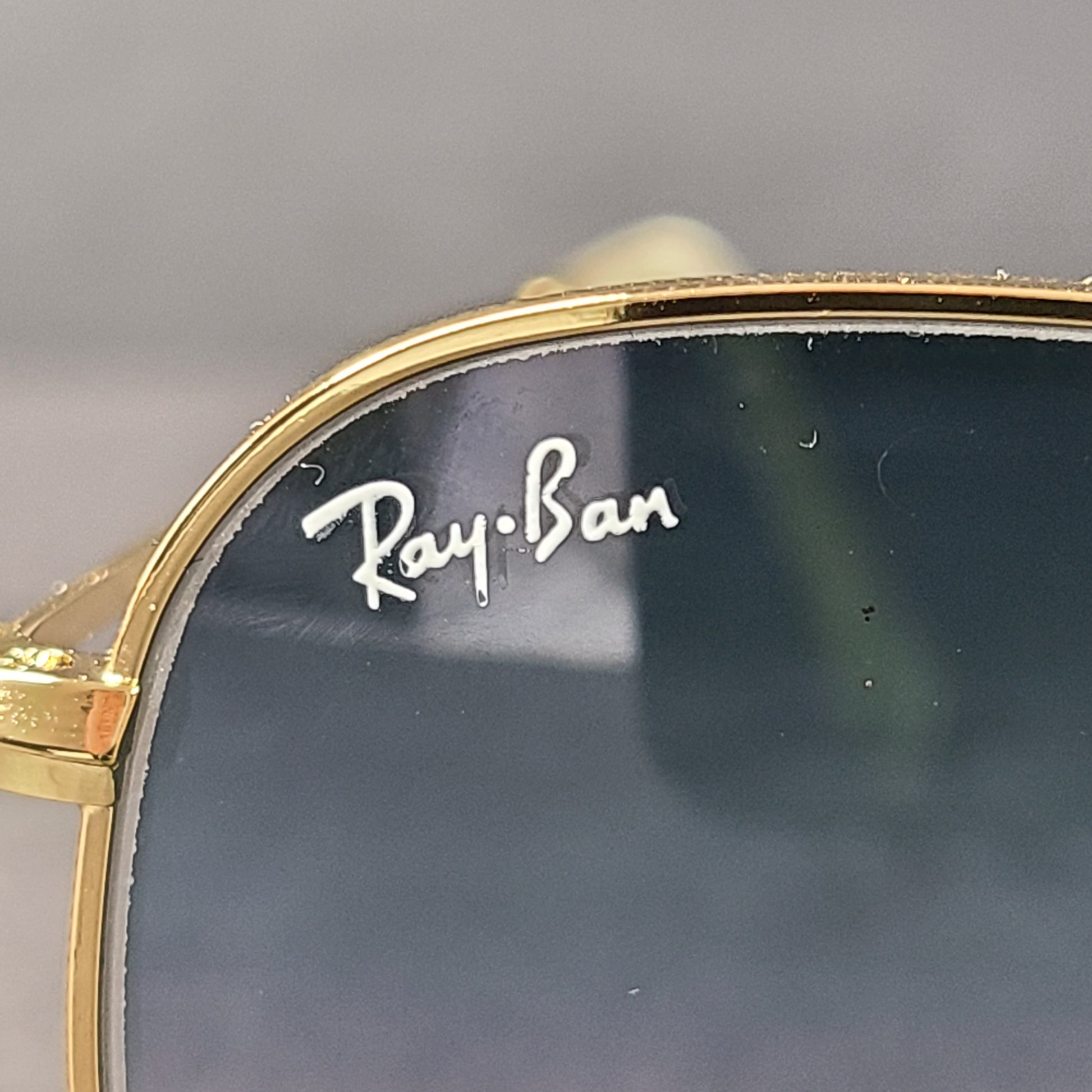 Fashionable Ray-Ban RB3548 Hexagonal Sunglasses with gold frames and blue lenses.