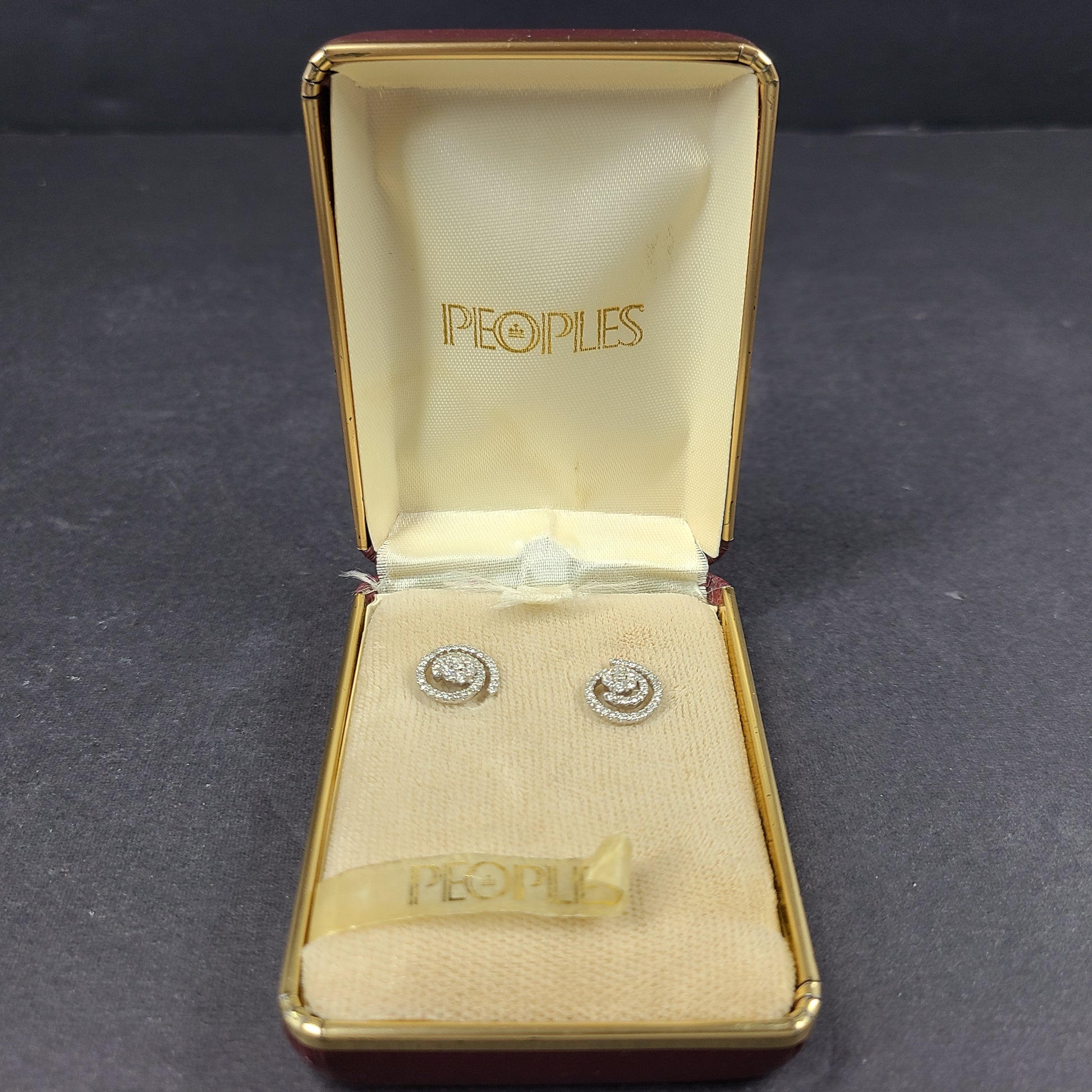 Pair of diamond swirl stud earrings in original box