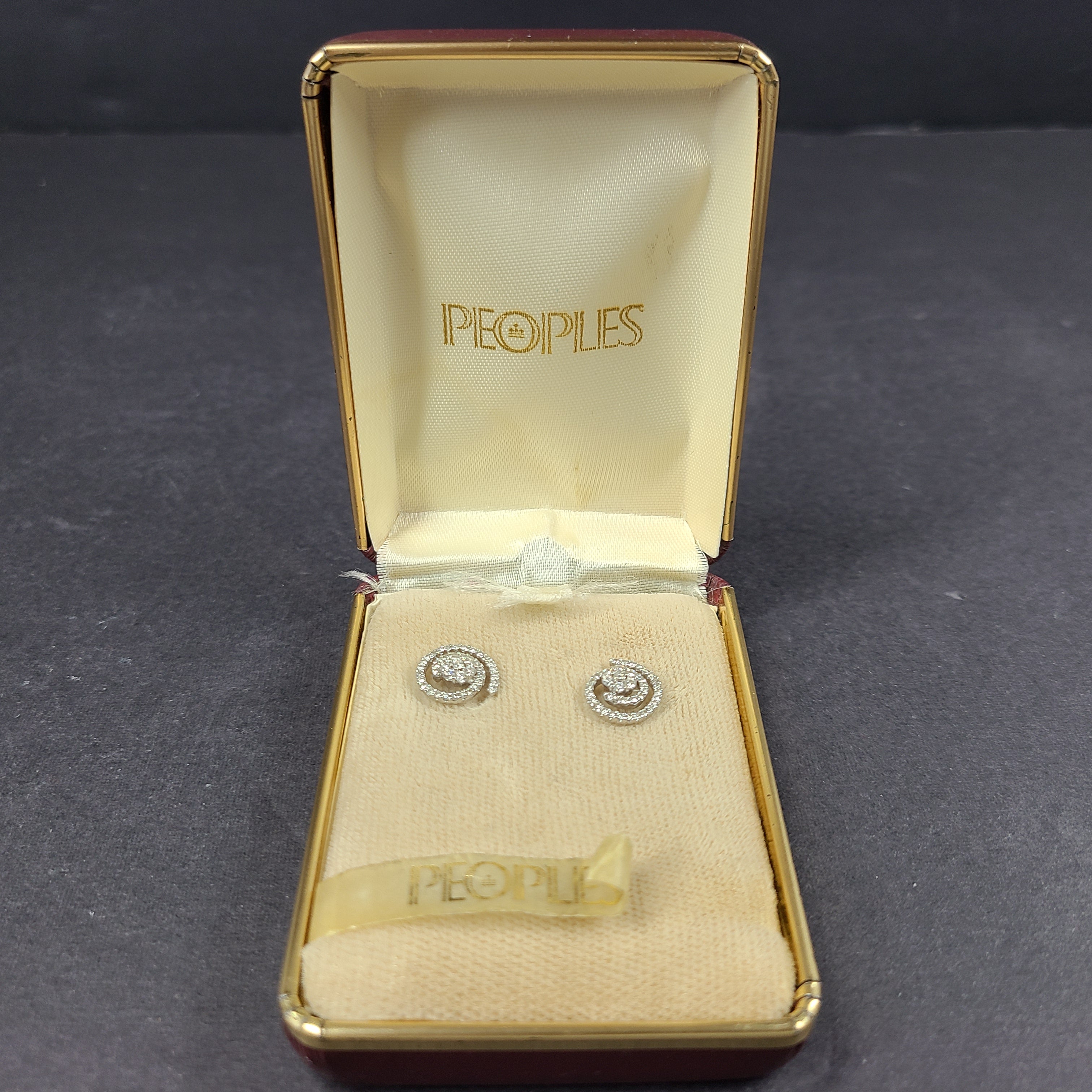 Pair of diamond swirl stud earrings in original box