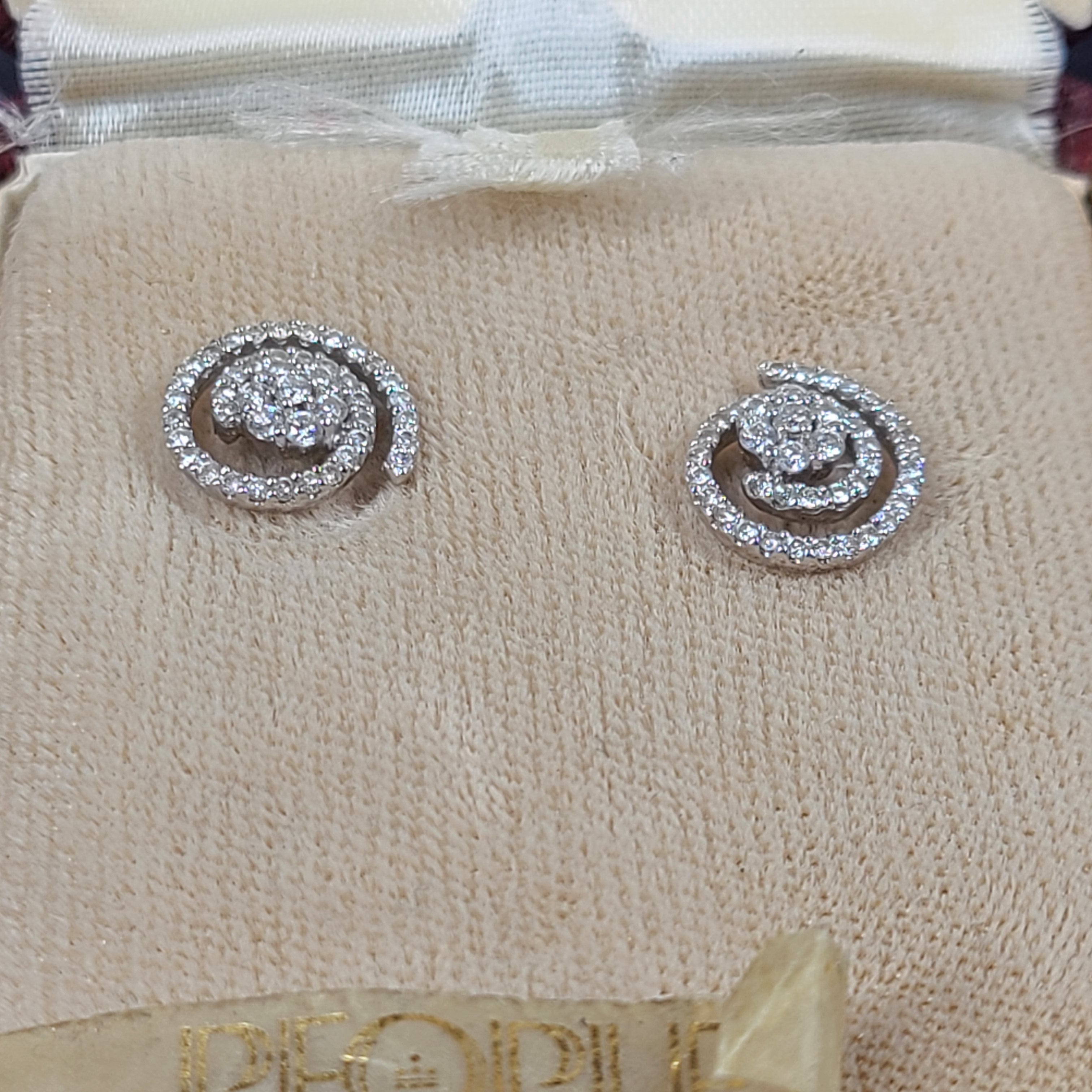 Pair of diamond swirl stud earrings in original box
