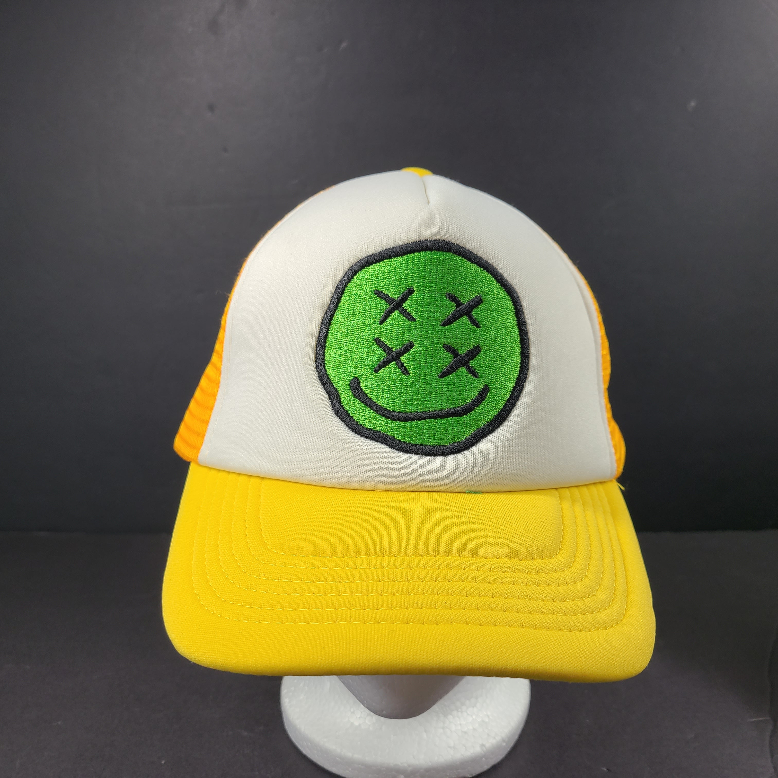 Comfortable Maison Article Trucker Cap in yellow and white mesh design.