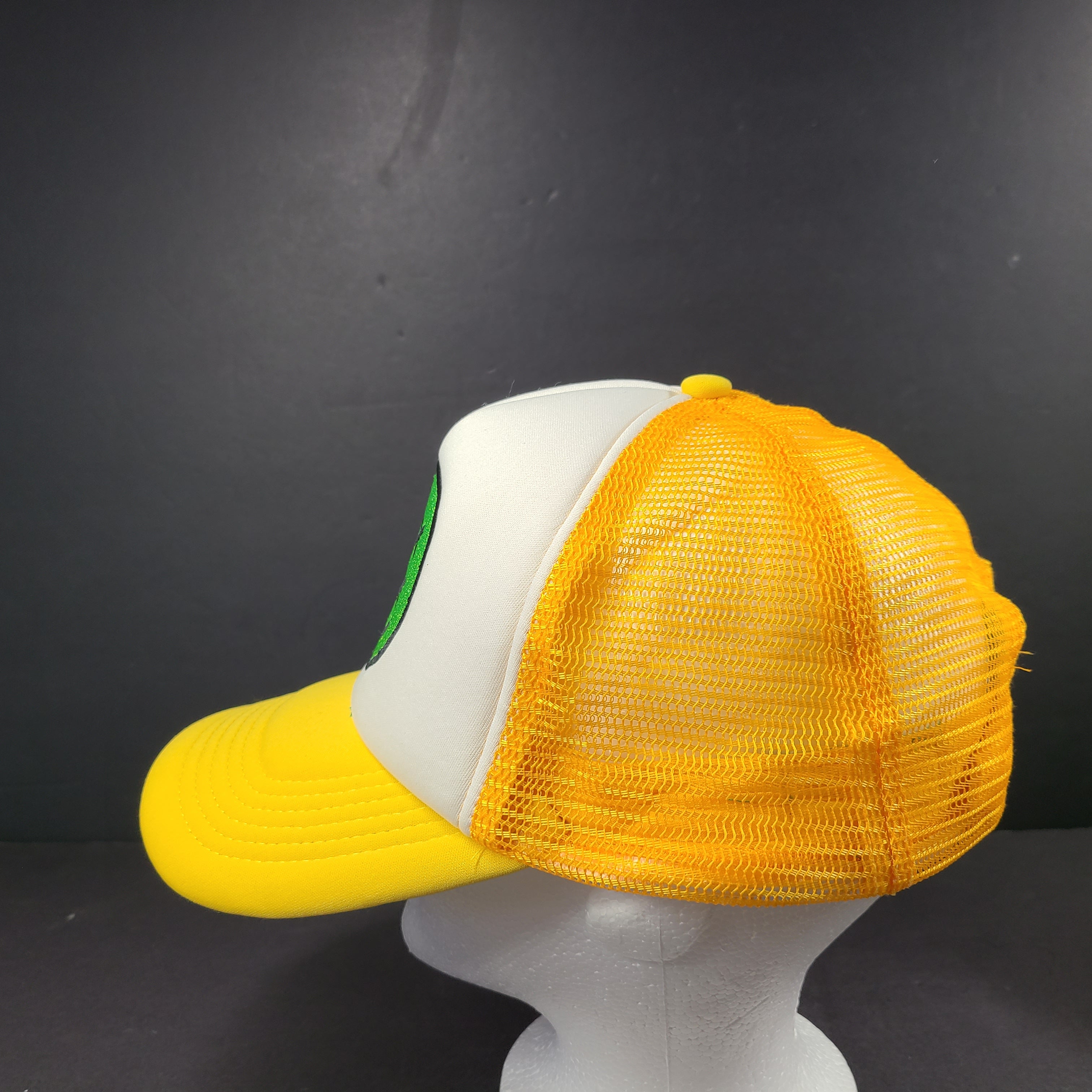 Comfortable Maison Article Trucker Cap in yellow and white mesh design.