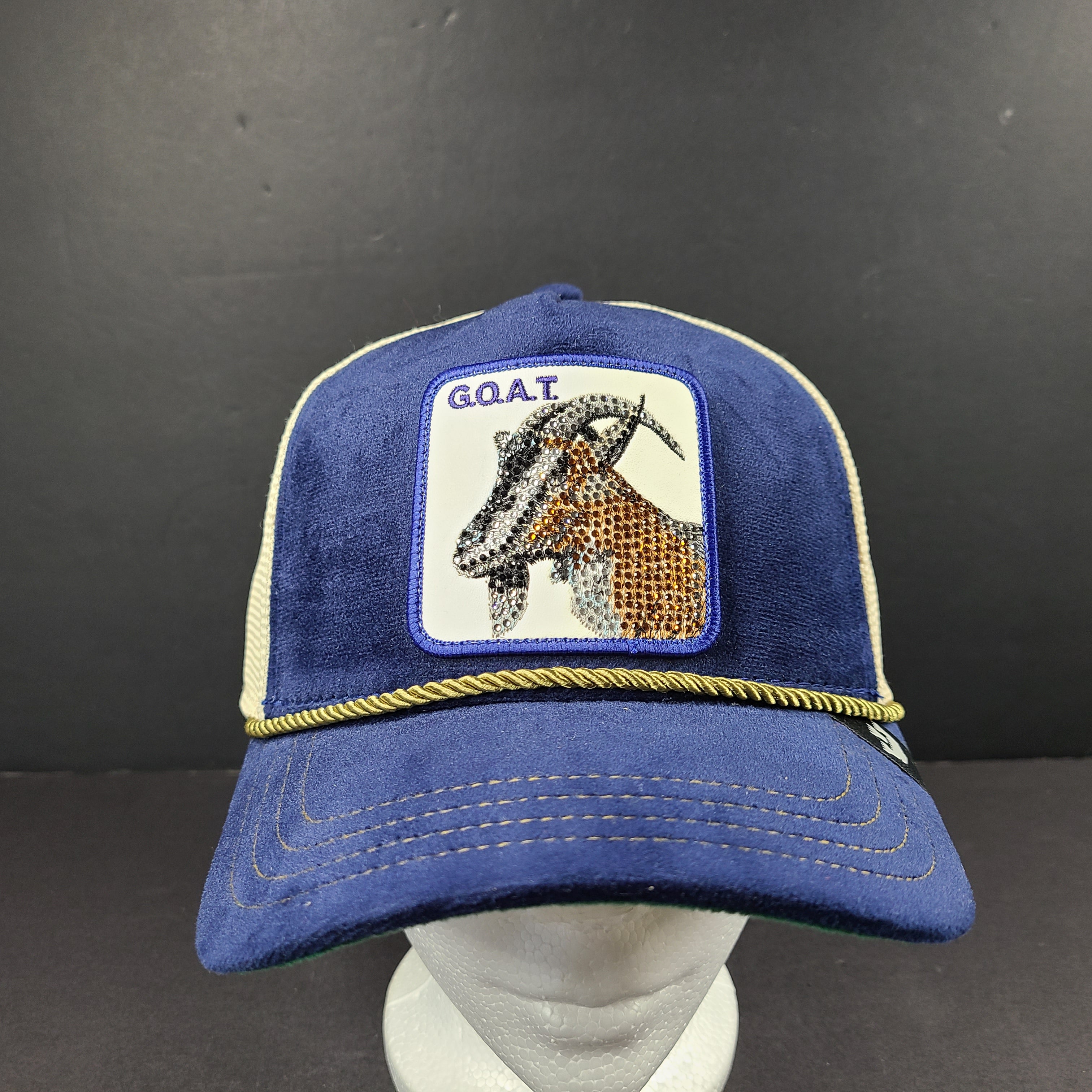 A stylish blue and beige trucker hat by Goorin Bros.