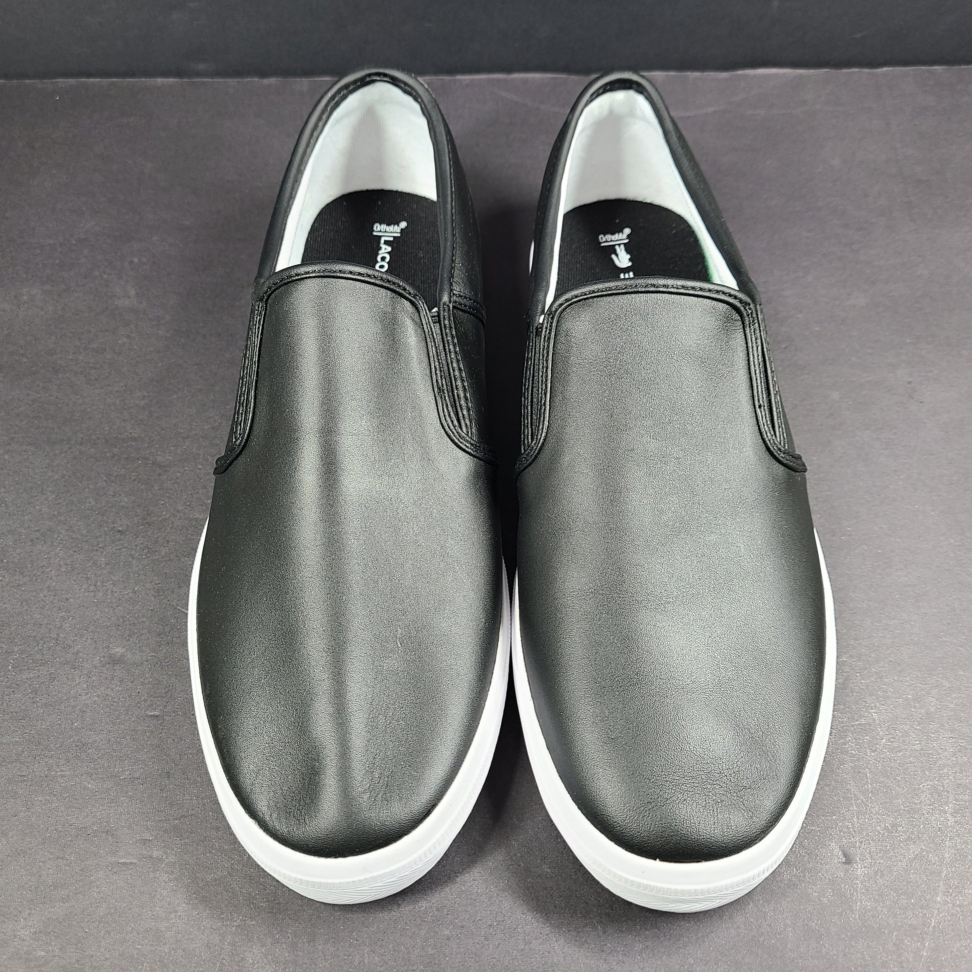 A pair of leather slip-on sneakers by Lacoste.
