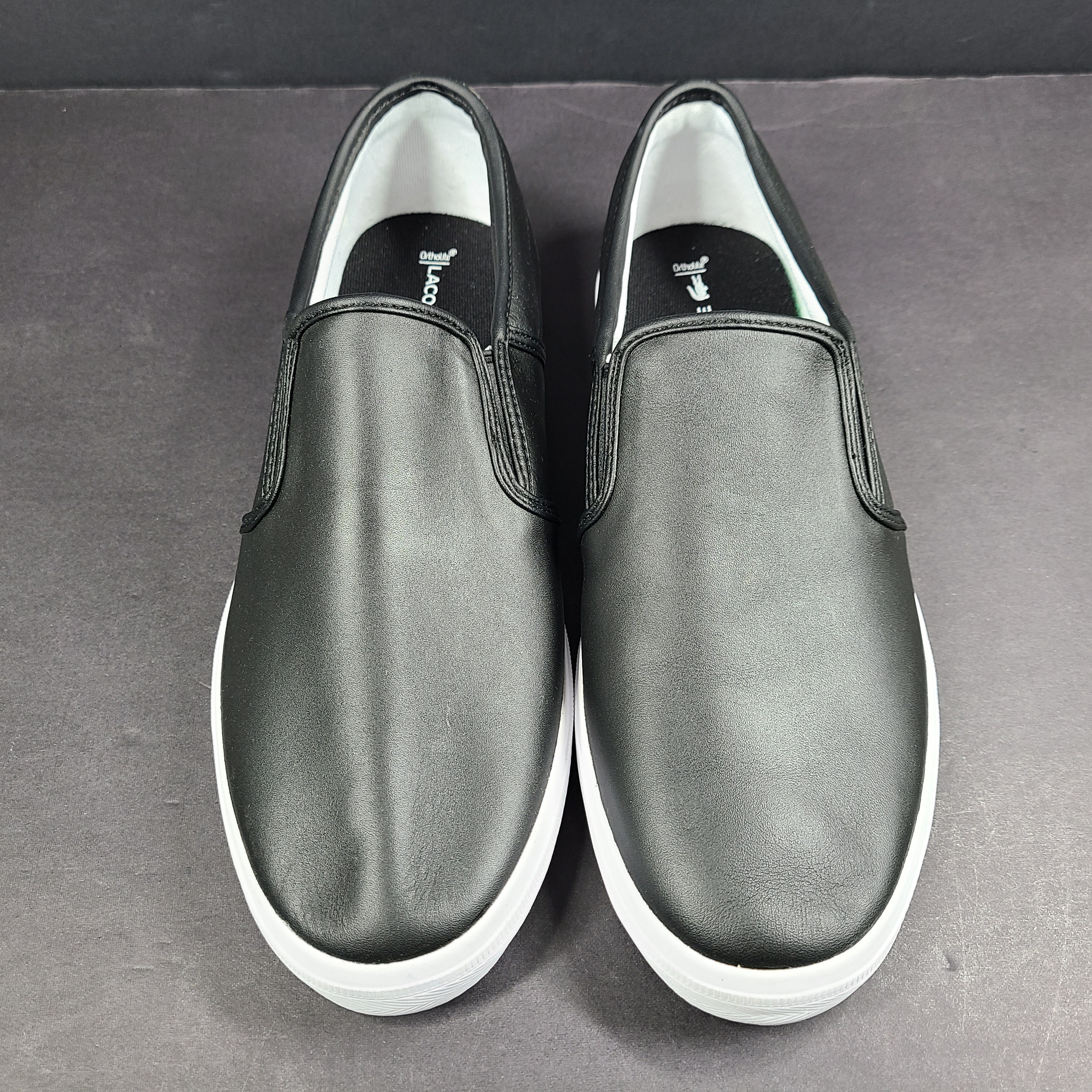 A pair of leather slip-on sneakers by Lacoste.