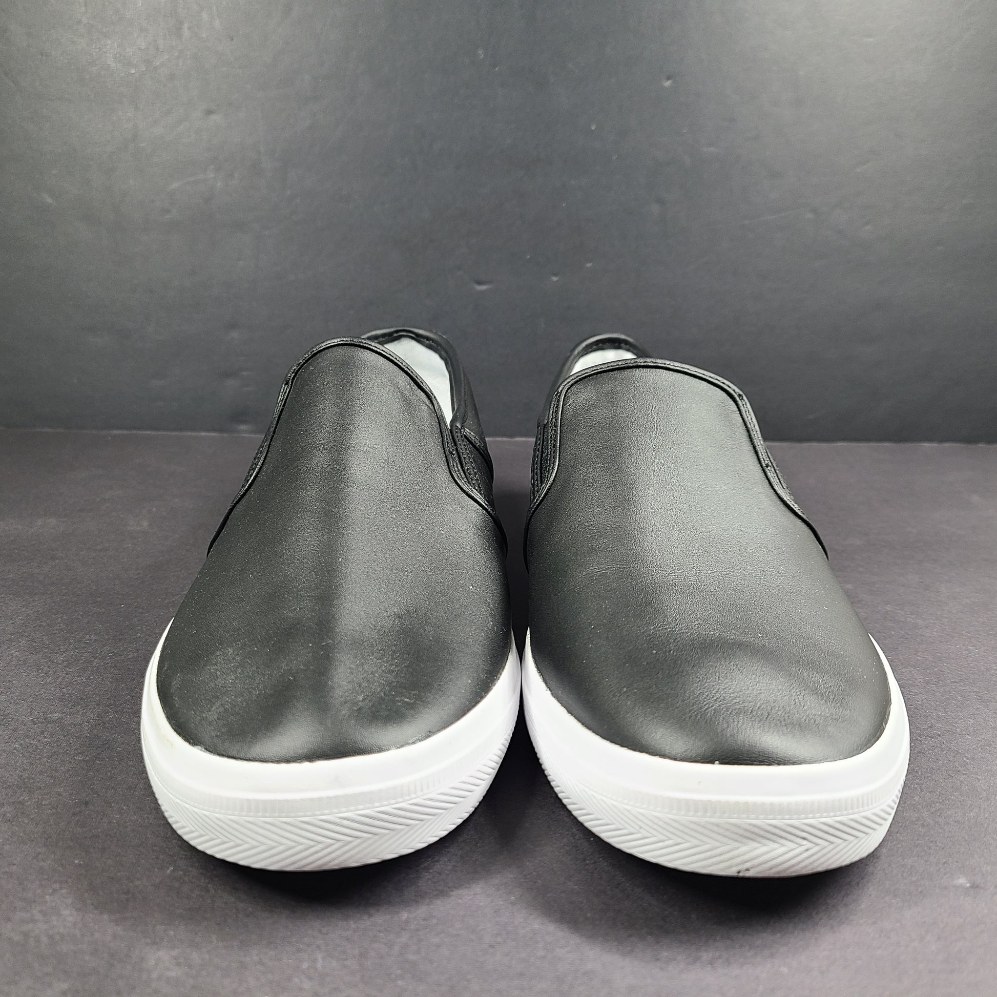 A pair of leather slip-on sneakers by Lacoste.