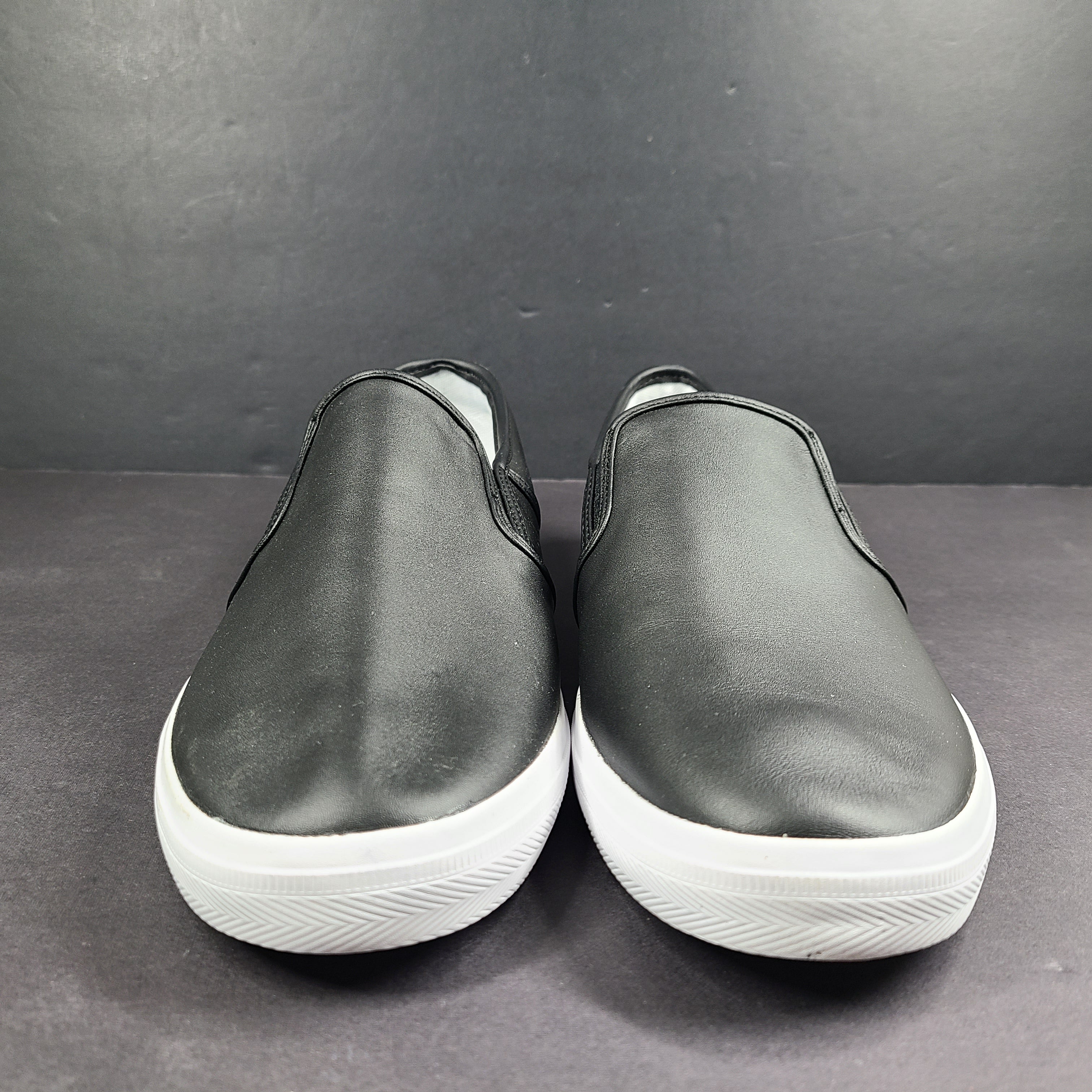 A pair of leather slip-on sneakers by Lacoste.