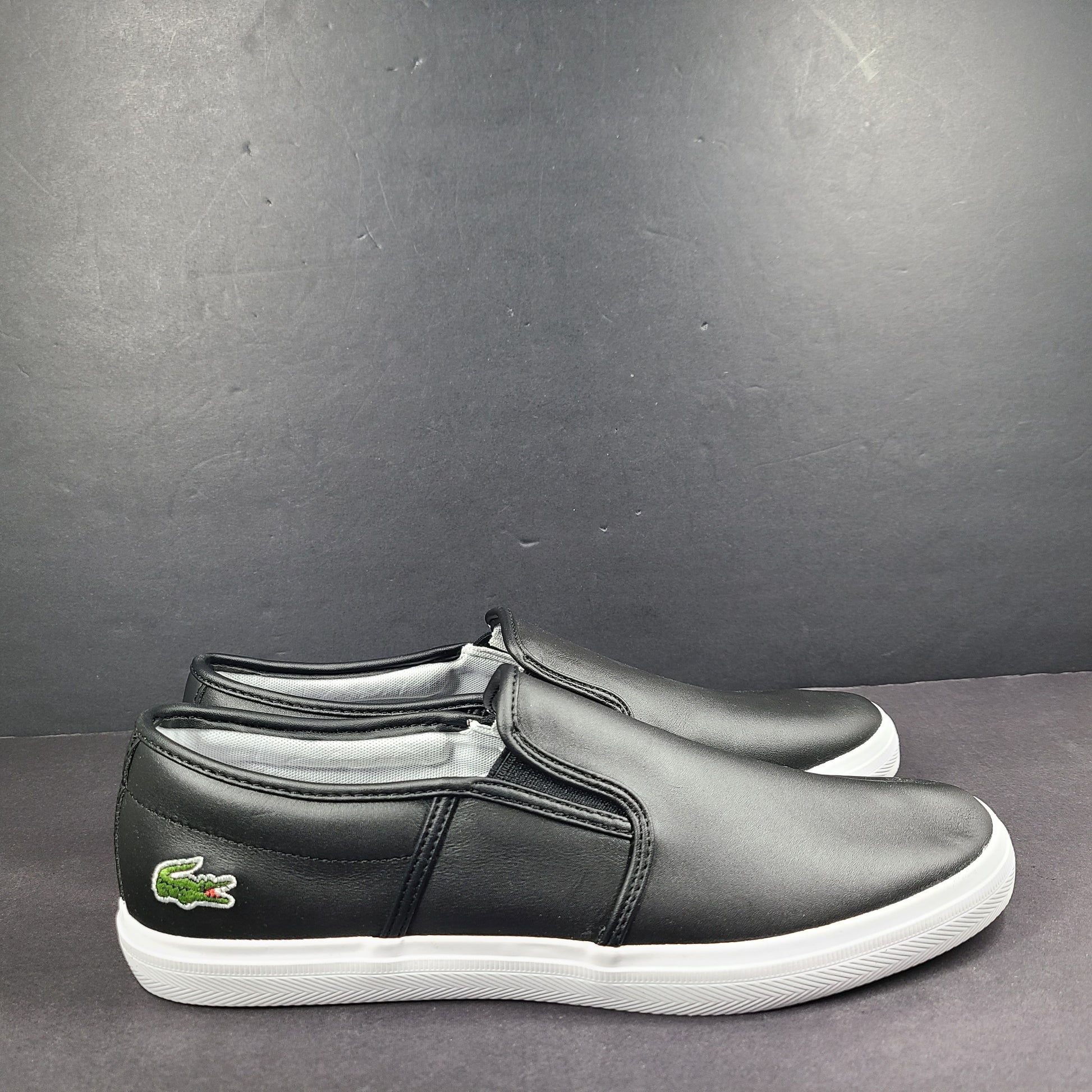 A pair of leather slip-on sneakers by Lacoste.