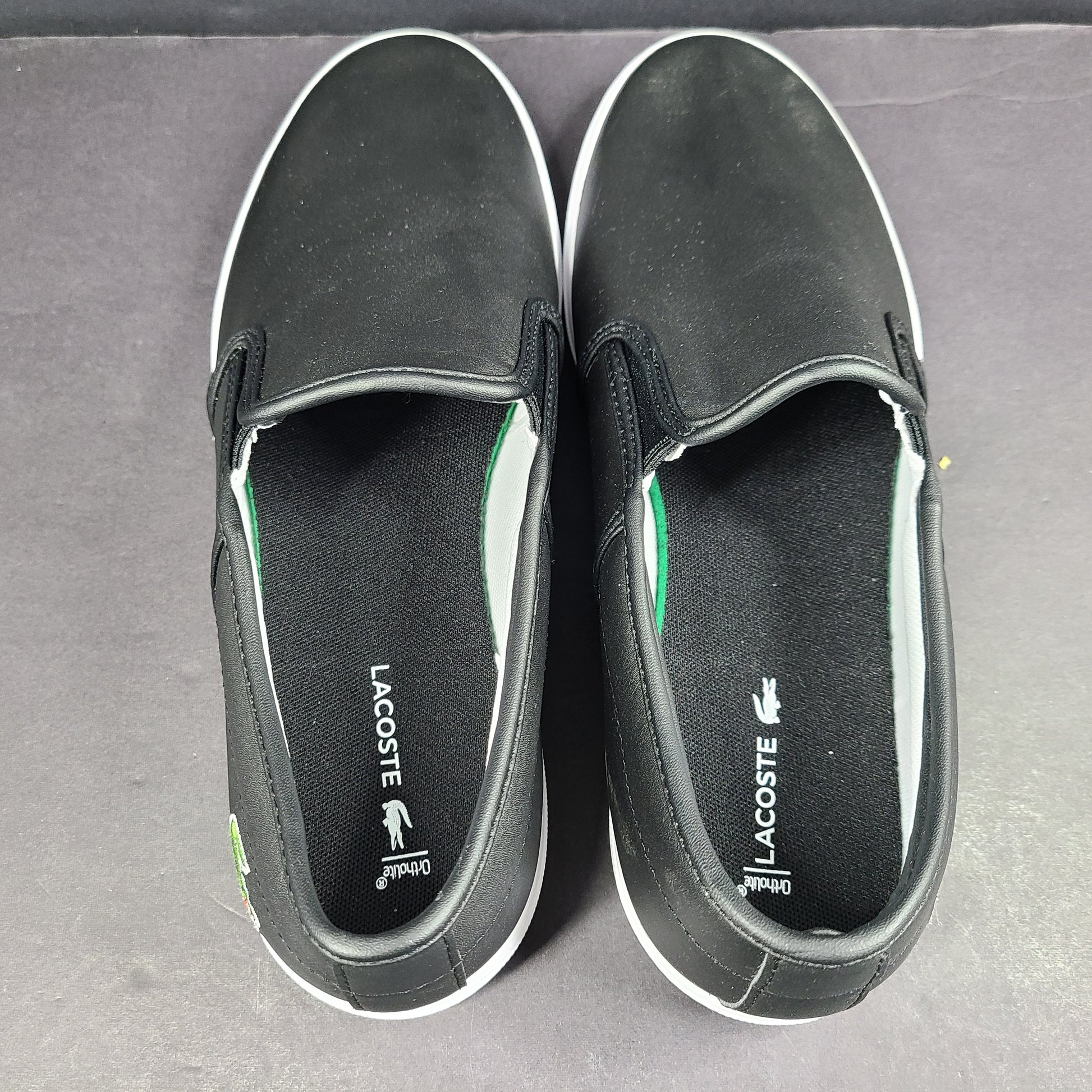 A pair of leather slip-on sneakers by Lacoste.