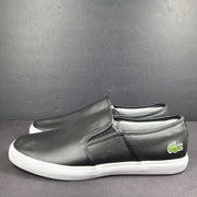 A pair of leather slip-on sneakers by Lacoste.