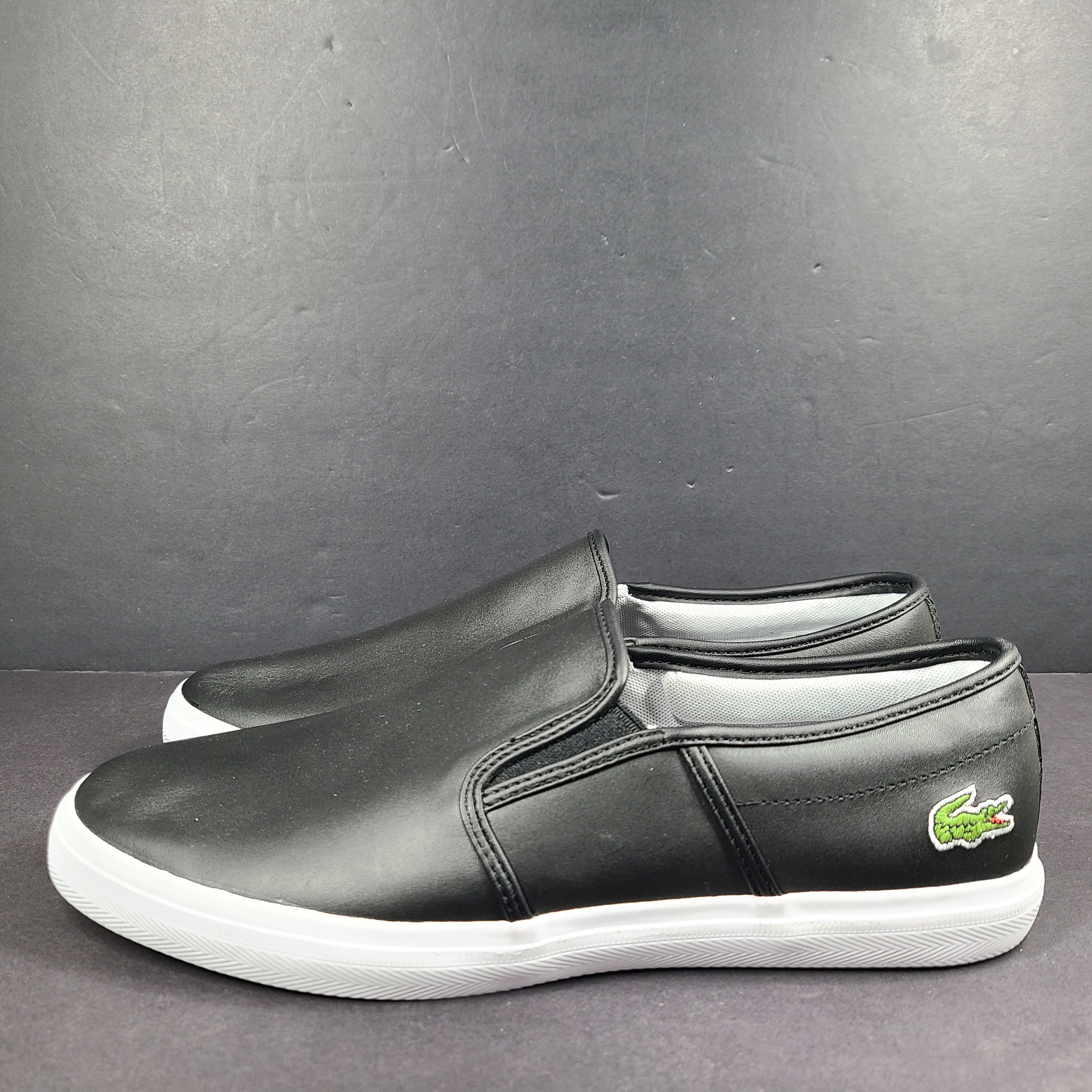 A pair of leather slip-on sneakers by Lacoste.